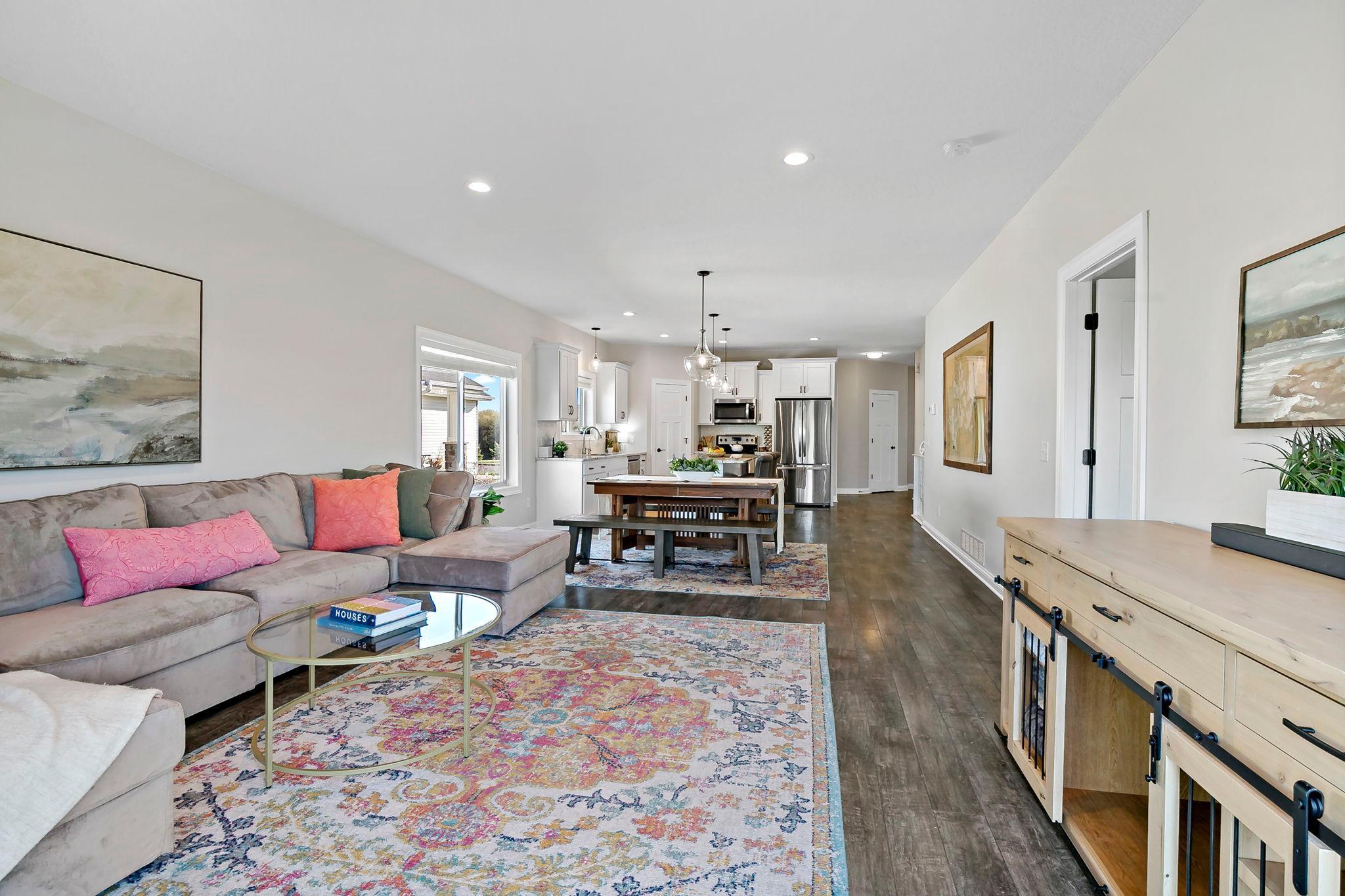 Spacious open-concept living and dining area flowing seamlessly into a modern kitchen.