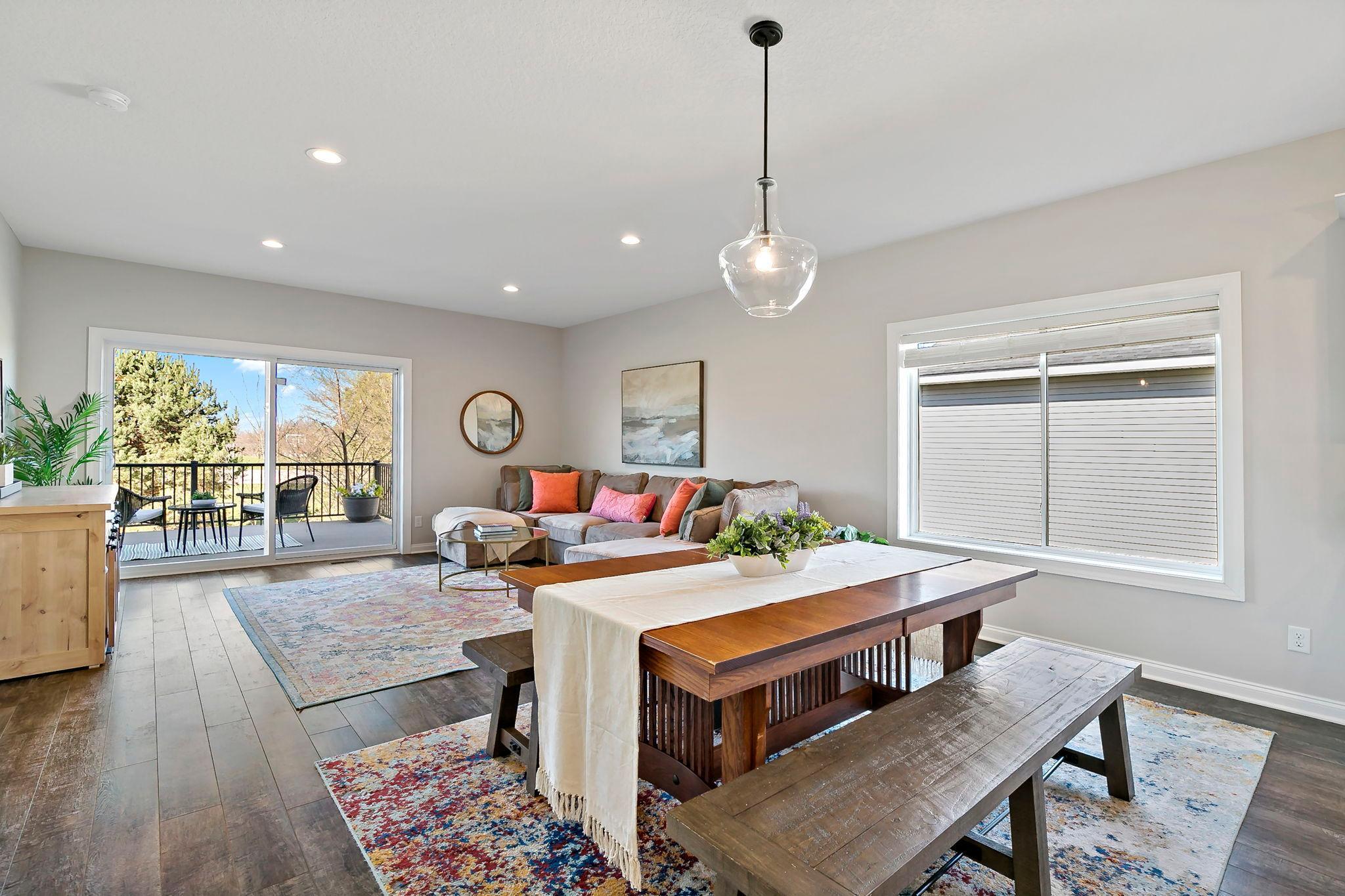 Open dining and living space with large windows and sliding doors leading to a private deck.