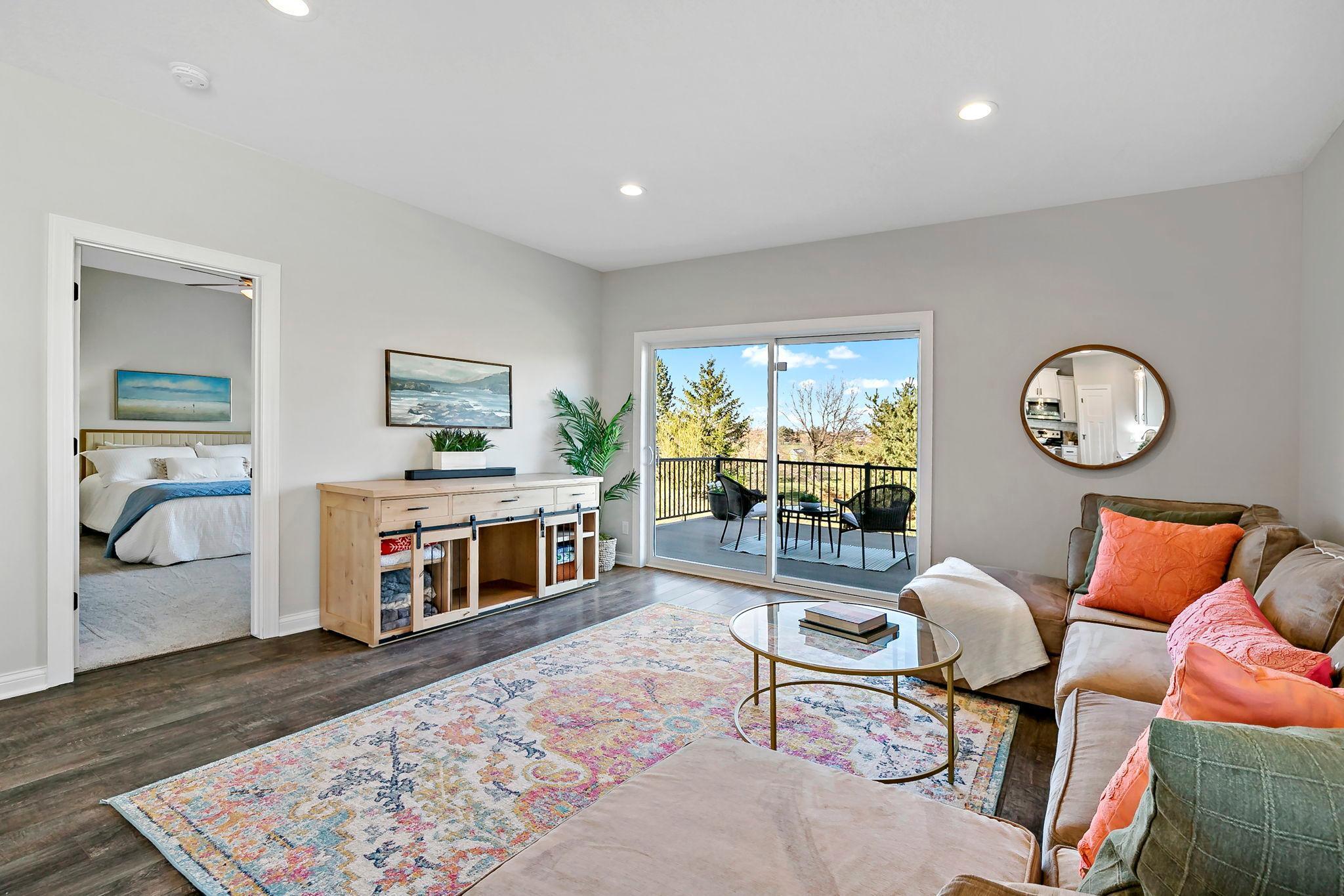 Cozy living area with deck access and adjacent bedroom for seamless indoor-outdoor living.