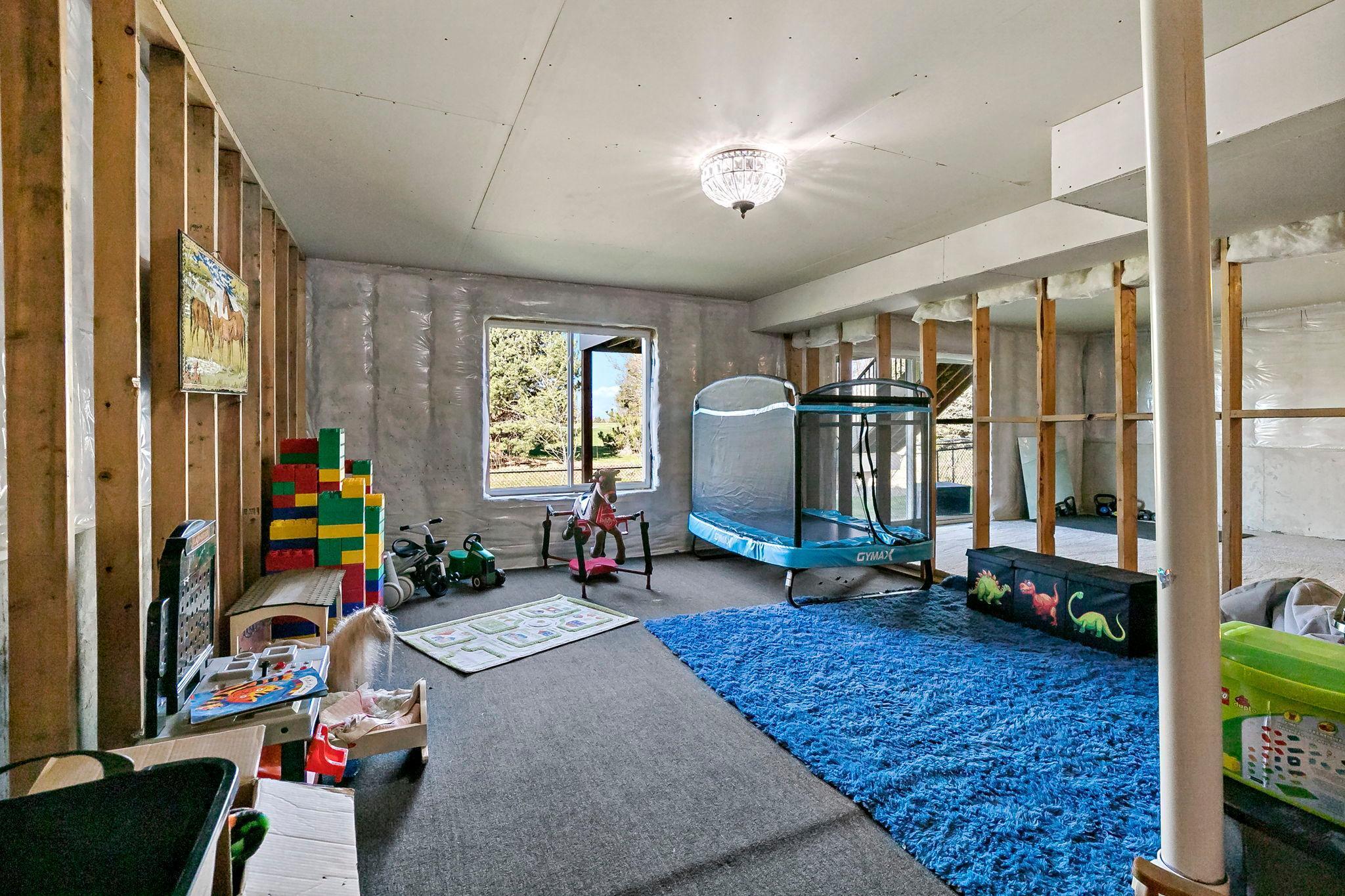 Spacious lower level with daylight window and flexible open area, perfect for a playroom, home gym, or future finished living space.