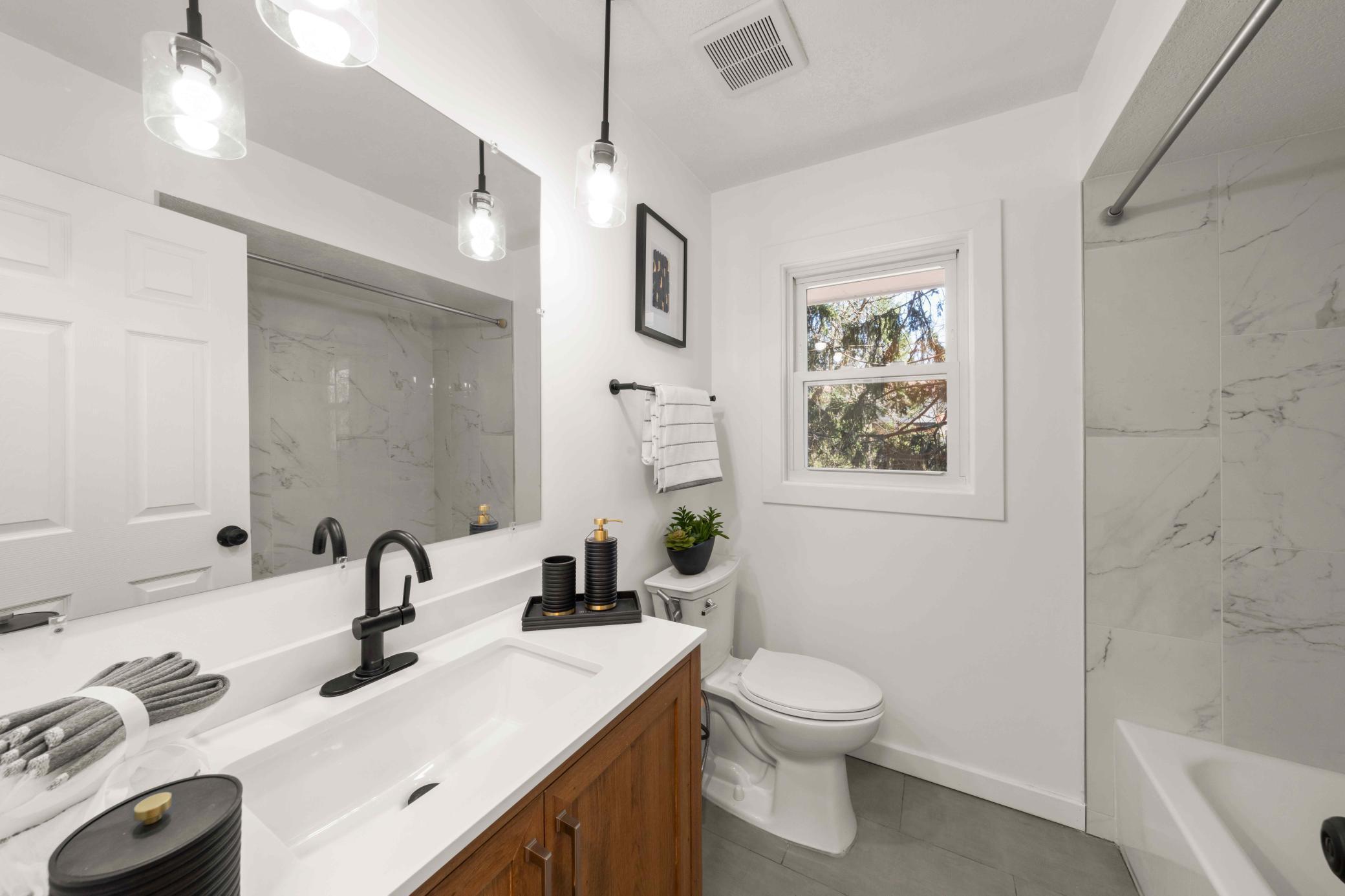 Updated bathroom on upper level with tiled shower