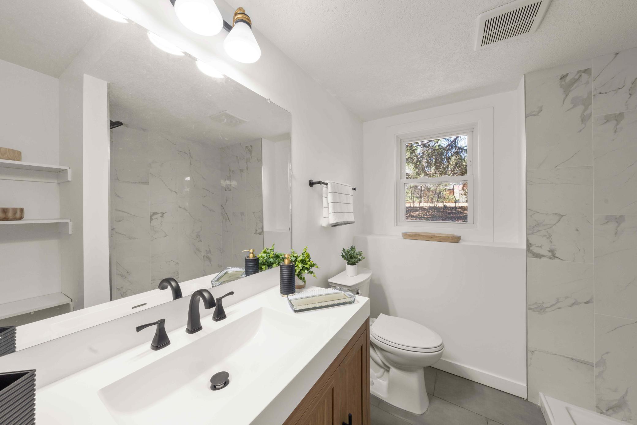 Updated bathroom on lower level with tiled shower