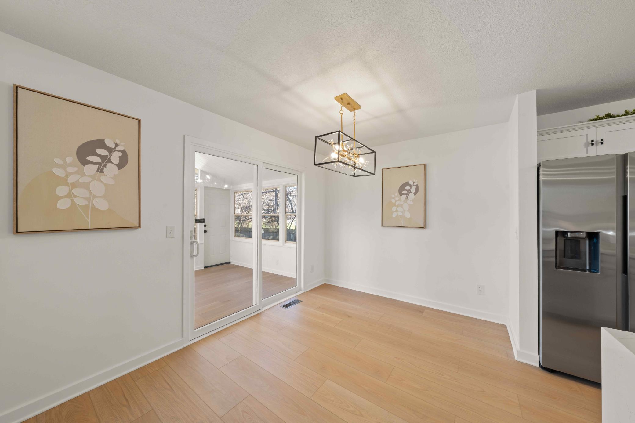 Open concept layout with dining, kitchen, living room and 3 season porch