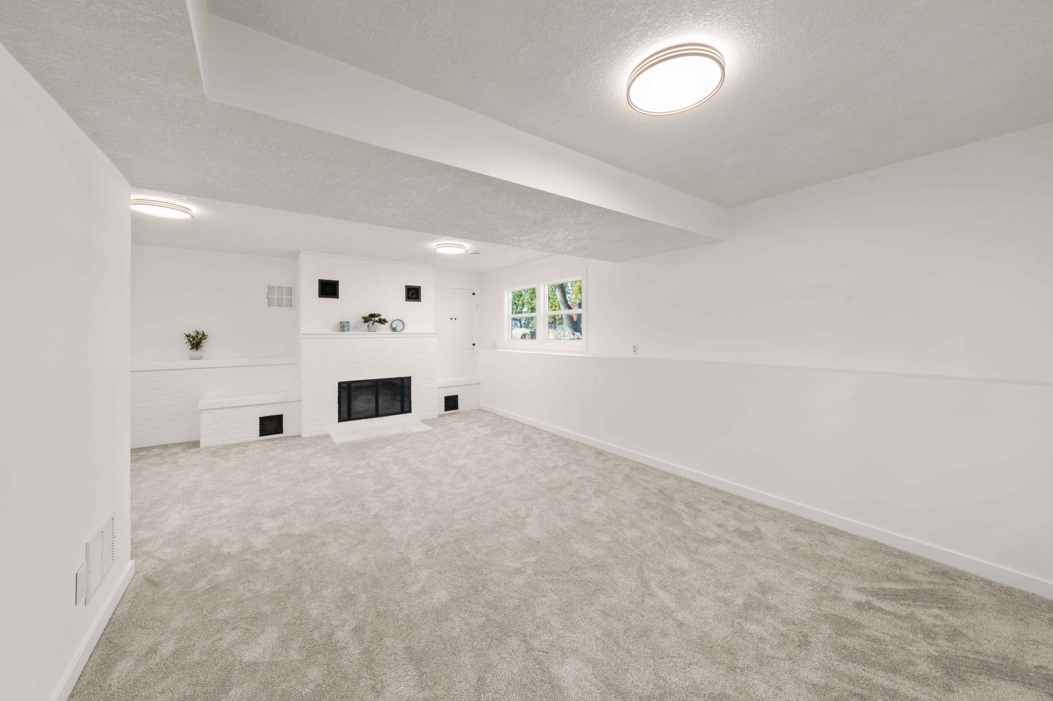 Lower level family room with wood burning fireplace to add warmth and style