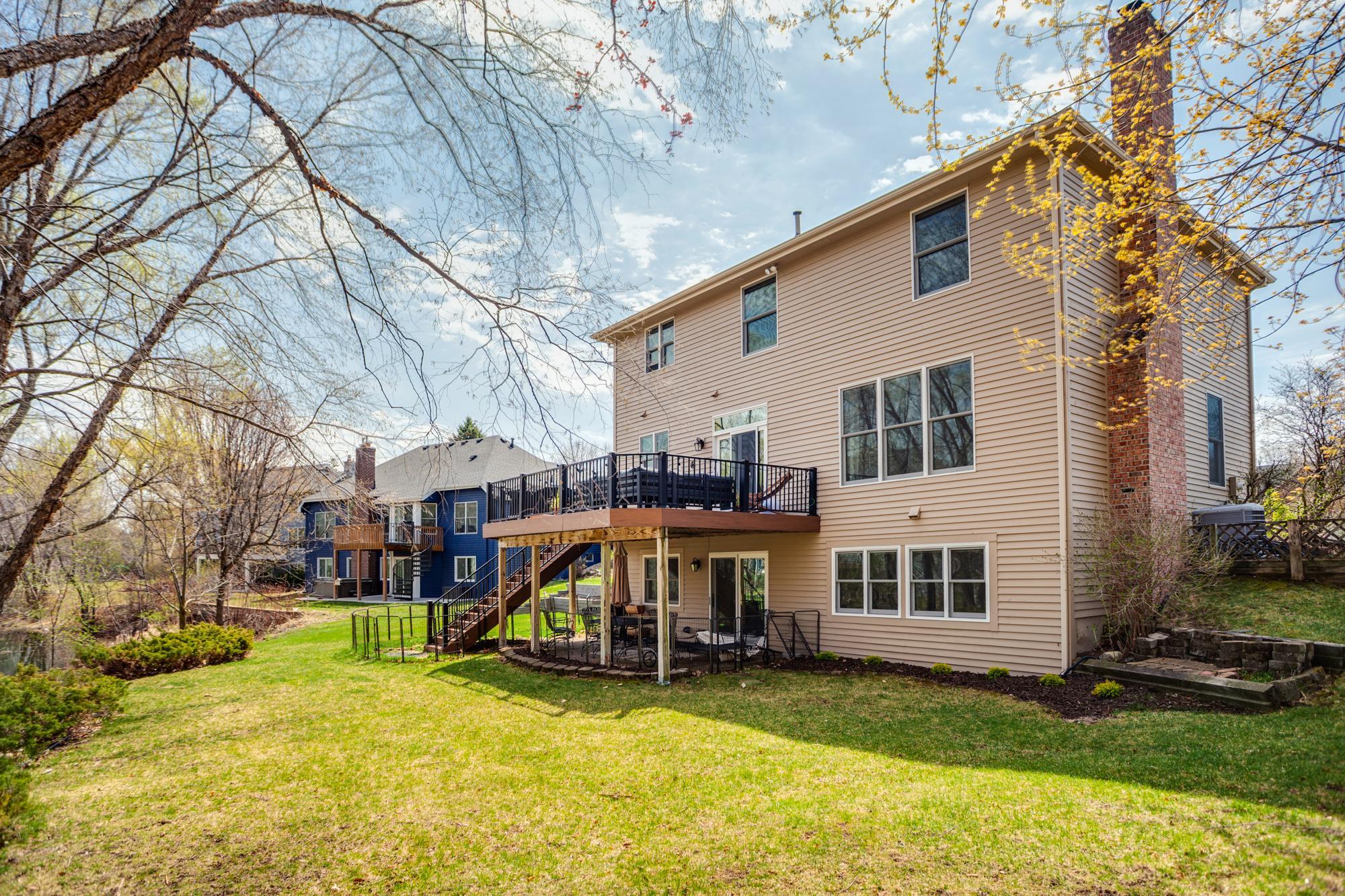 Elevated decking and a walkout lower level create inviting outdoor living spaces.