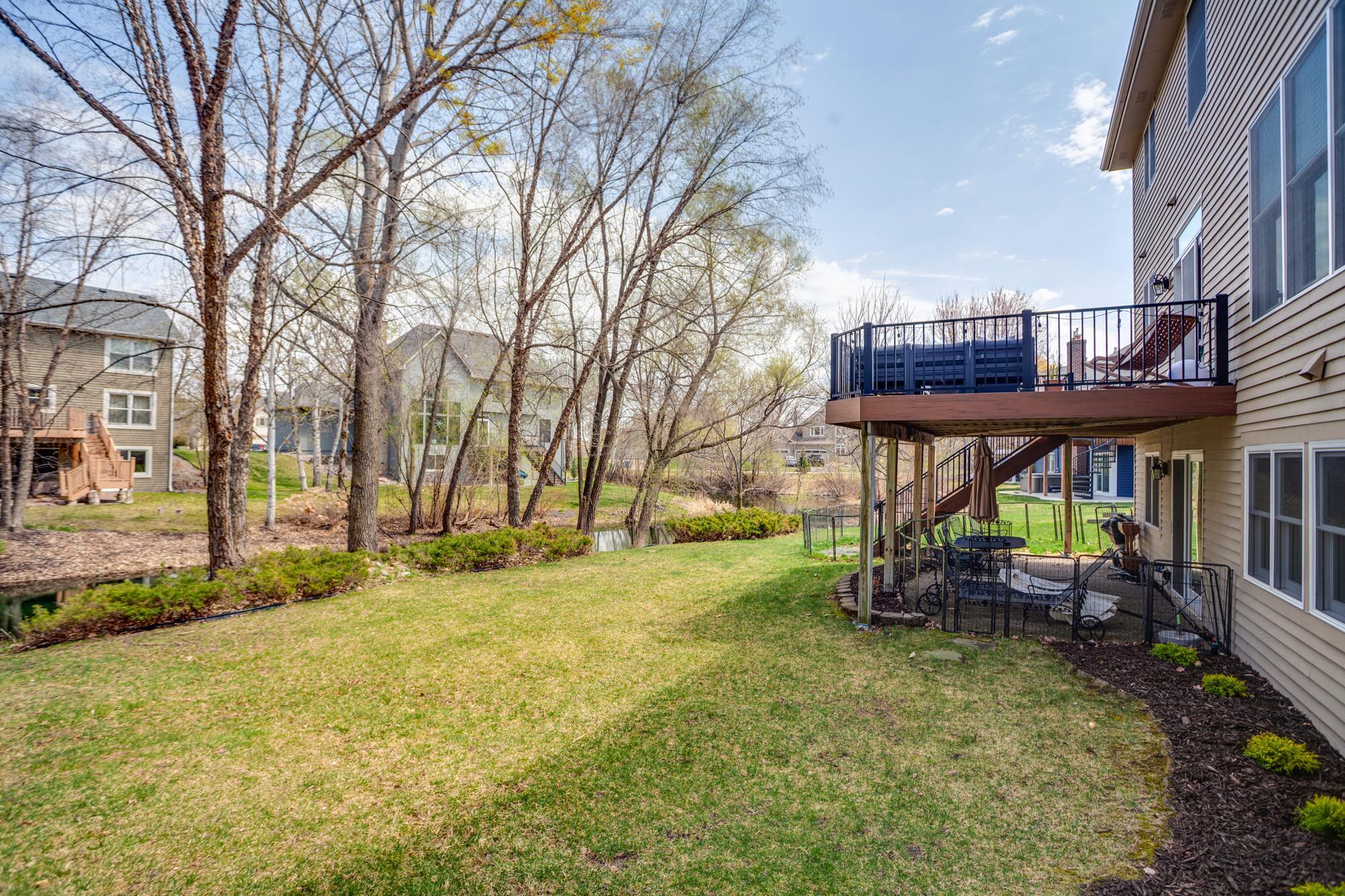 Spacious backyard offers plenty of open green space for games and pets, while gently sloping to the water’s edge, perfect for relaxing, entertaining, and enjoying nature right in your backyard.