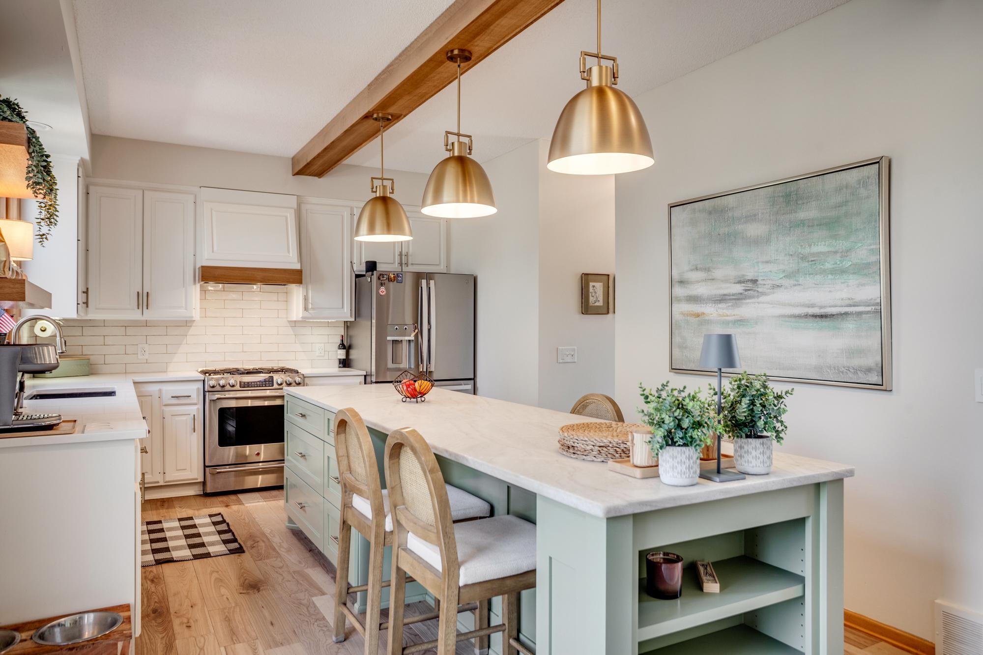 A spacious center island with seating anchors the space, while warm wood accents and statement lighting add character.