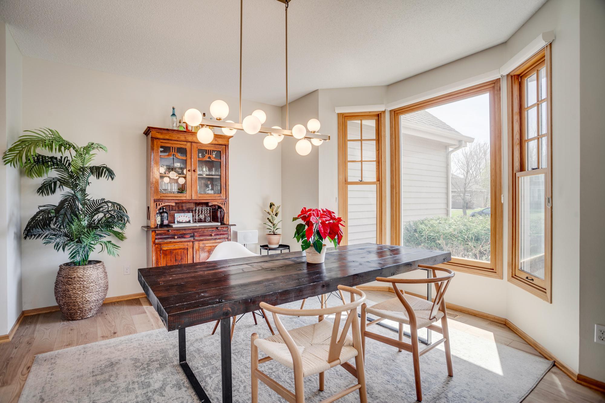 Formal dining room is highlighted by beautiful, bayed windows that fill the home with natural light, while new white oak hardwood flooring flows throughout the main level, adding warmth and continuity to the open, airy design.