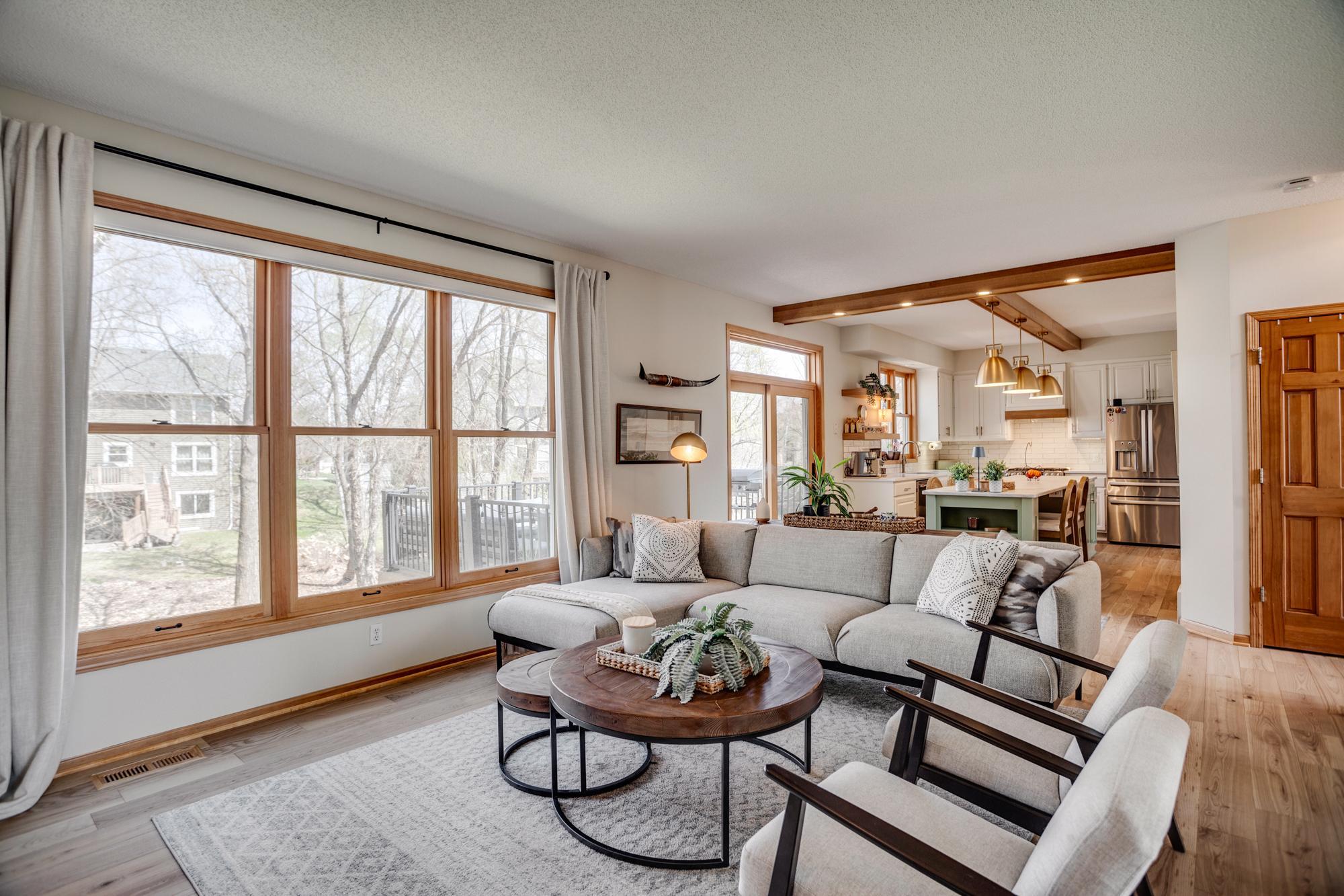 The stunning white oak hardwood flooring continues within the open design of the home's everyday spaces as the family room connects effortlessly to the beautifully updated kitchen.