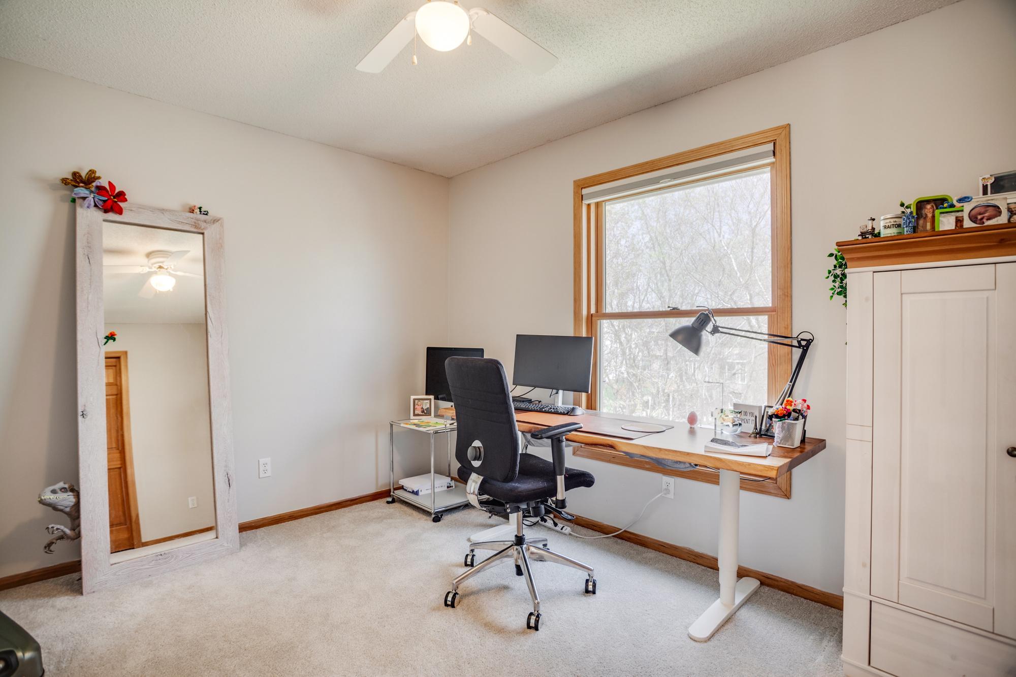 Neutral decor in the bedrooms allows added versatility like this home office set-up.