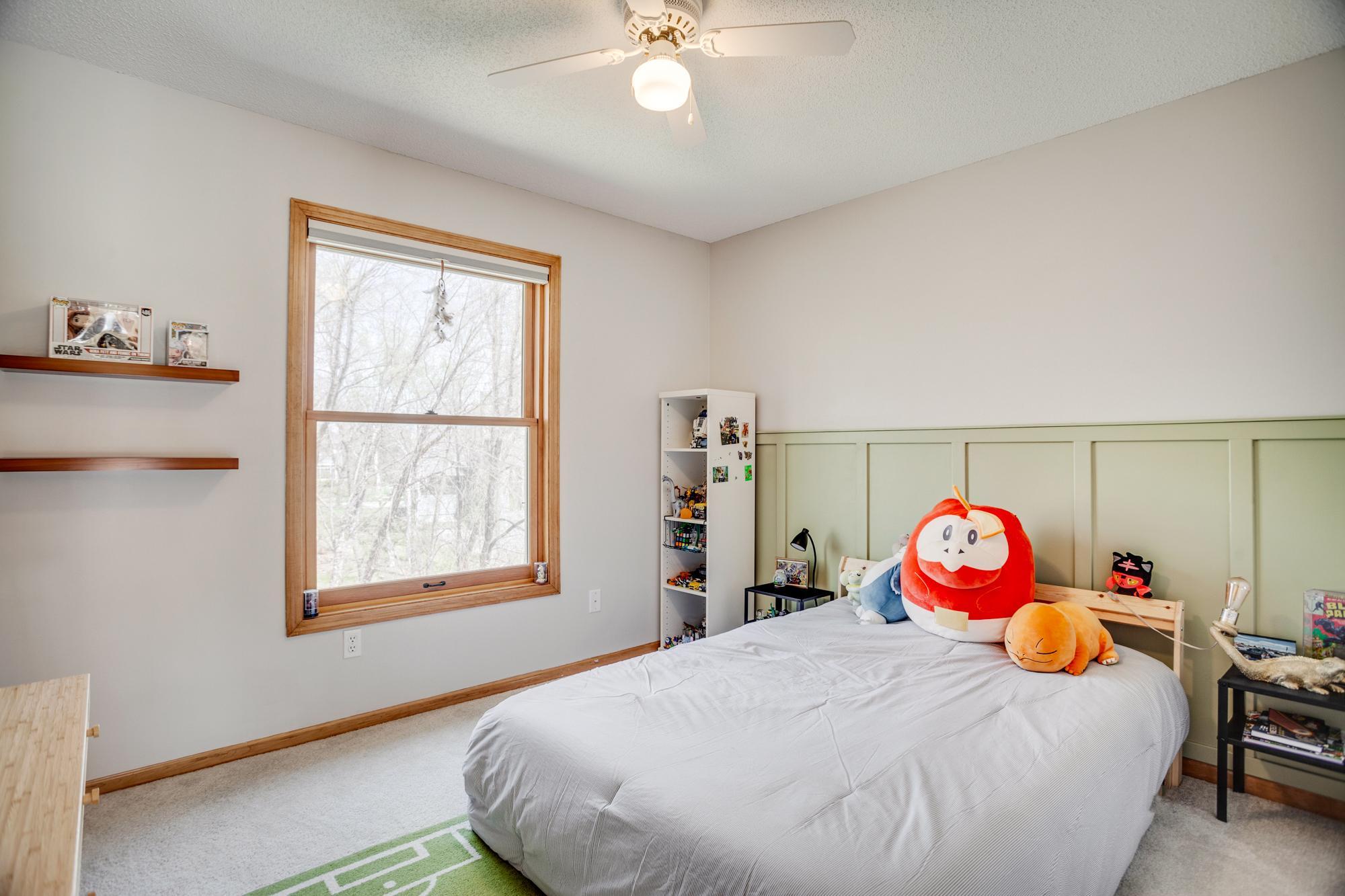 You will find 4 bedrooms total within the private upper level, including this spacious bedroom with lovely wainscoting accents.