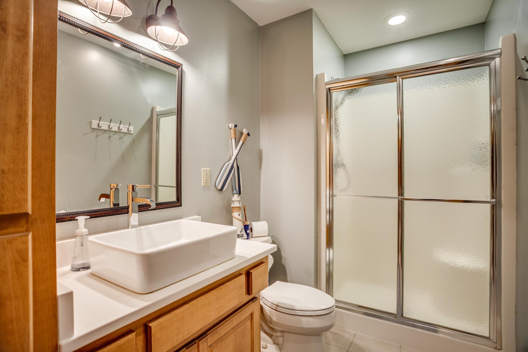 A fourth updated bath is located in the walk-out lower level with new countertop, vessel sink and fixtures.