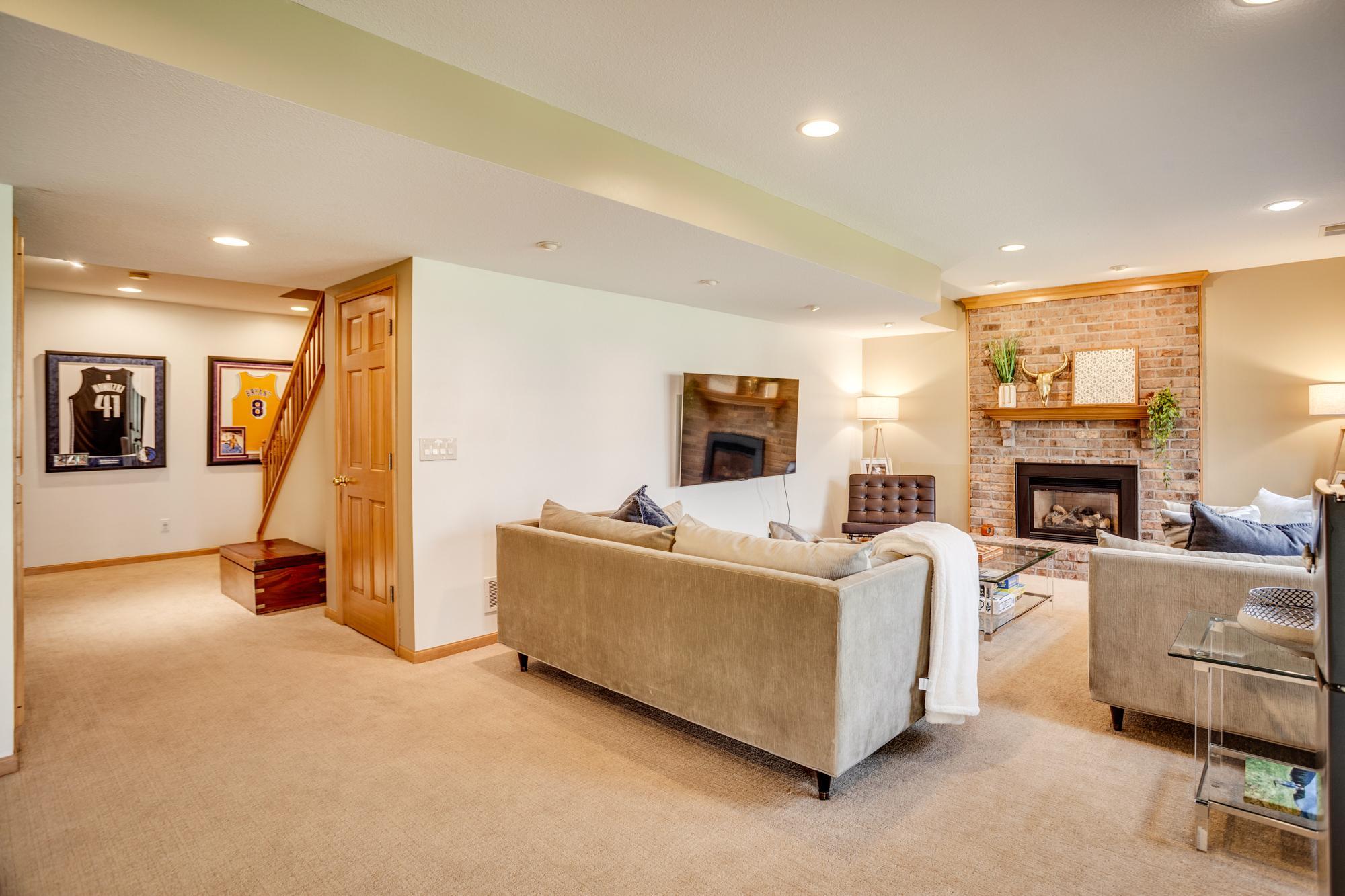 The walk-out lower level offers a spacious and inviting family/amusement room, perfect for relaxing or entertaining, and ready to accommodate your media needs.