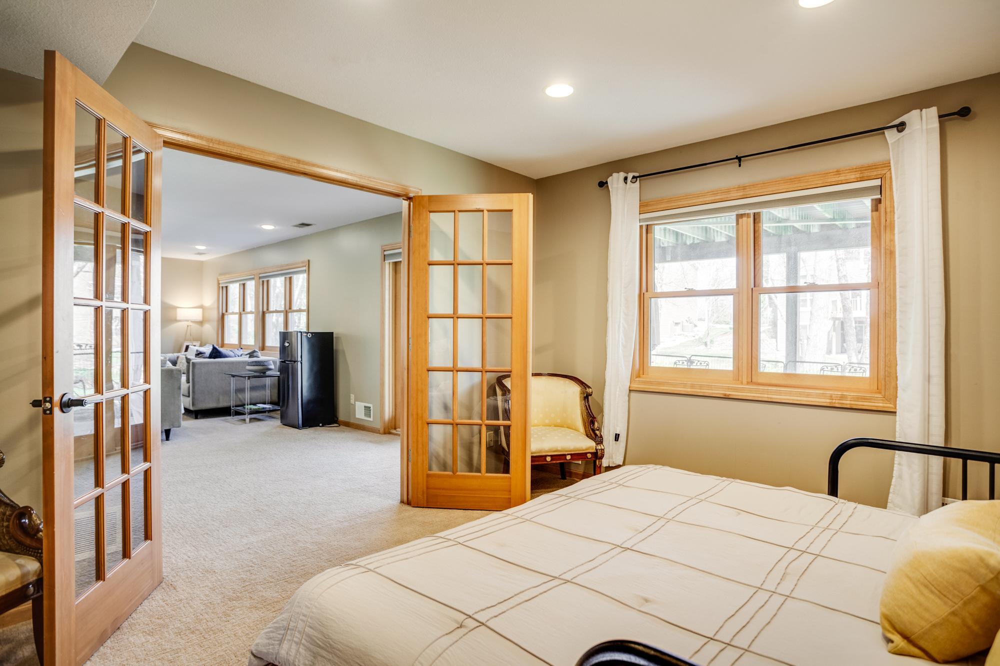 Glass French door entry allows the space to connect to the entertainment ready lower level or close for added privacy. This room also features a walk-in closet for added storage.
