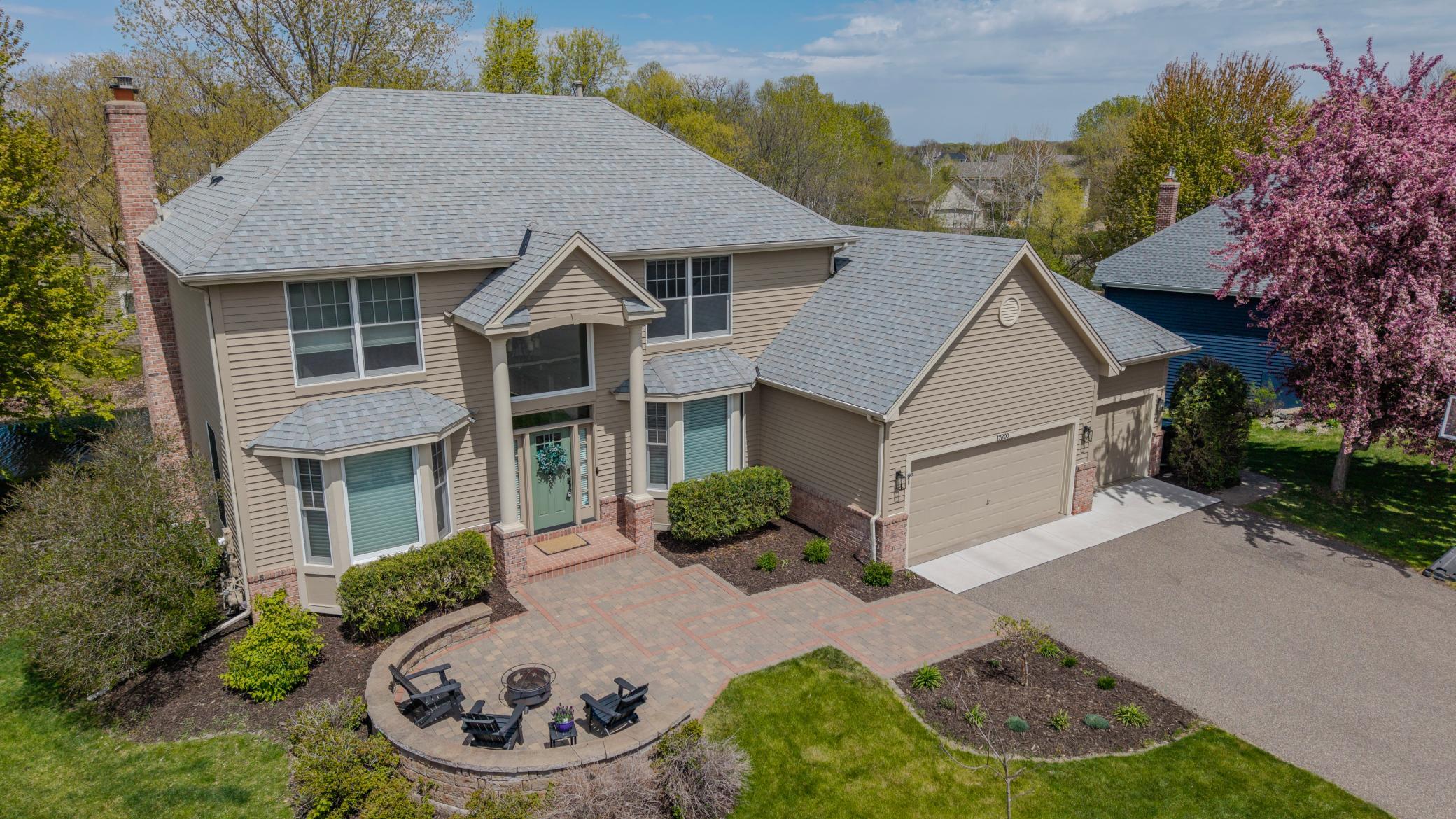 Oversized, circular paver patio is very spacious creating a fabulous outdoor gathering space at the front of the home while also enhancing the home's fabulous curb appeal.