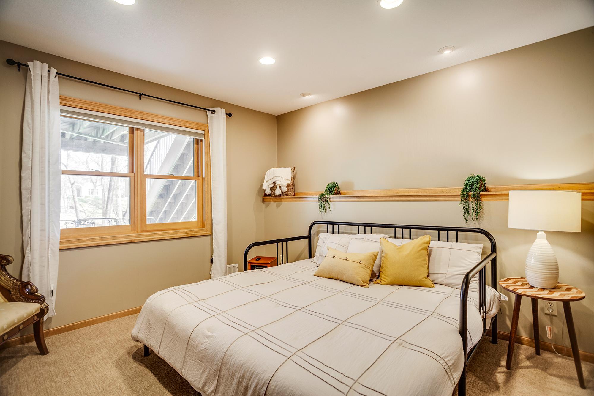 The lower-level bedroom is a flex space which could also be utilized as quiet home office, exercise room, or craft area.