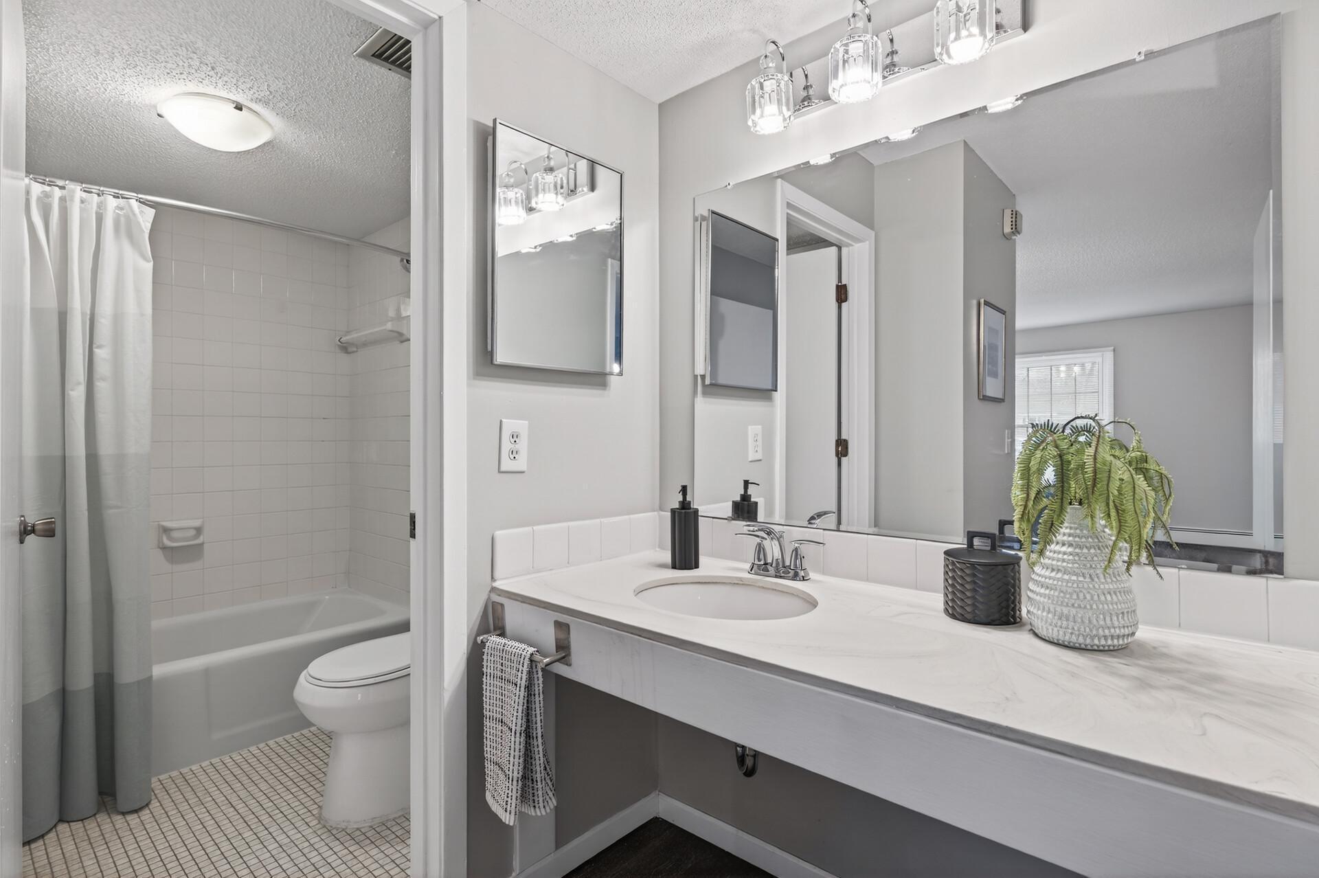 The bathroom with the vanity located outside of the toilet/bath space