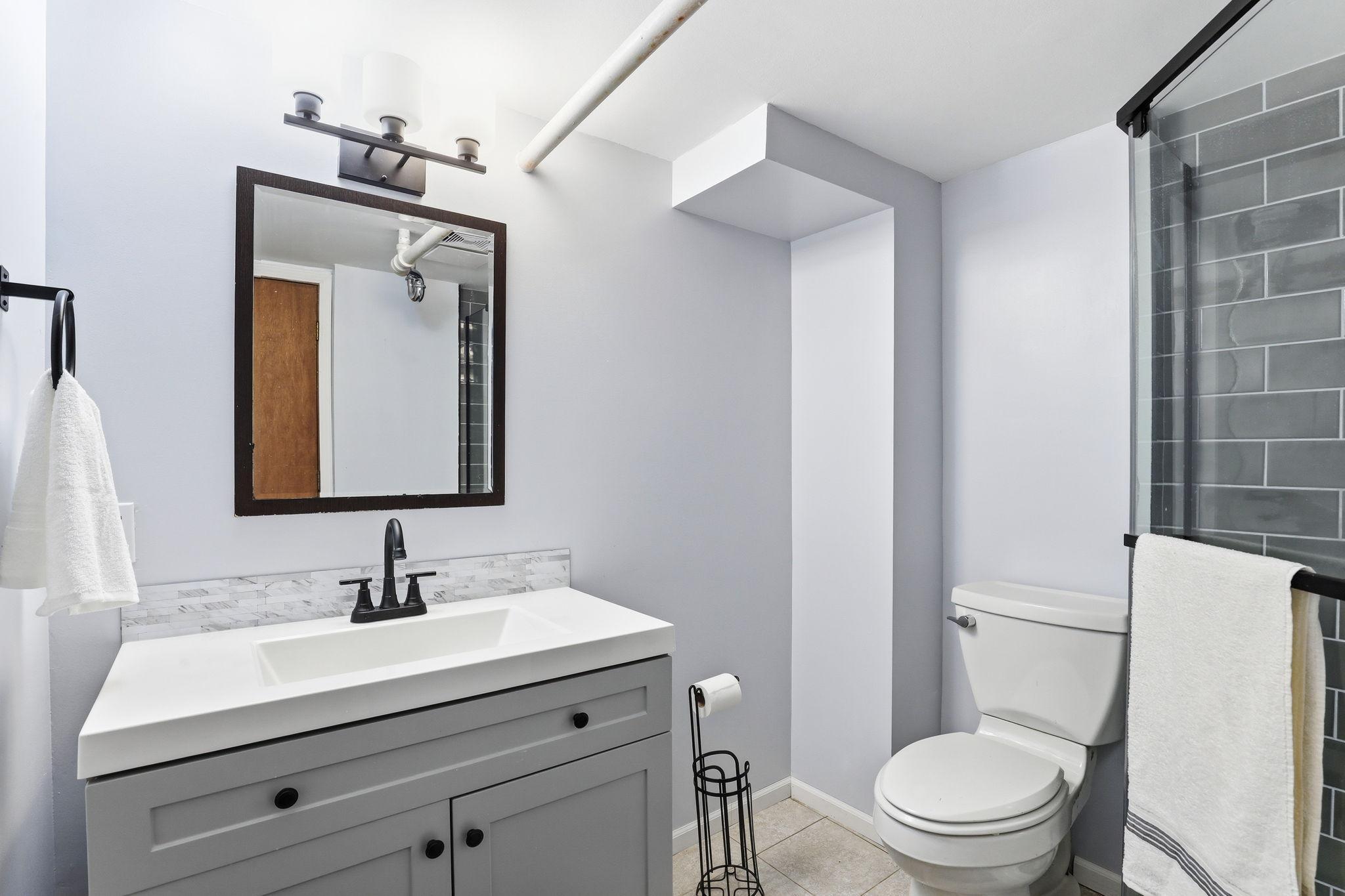 A newly updated 3/4 bath on the lower level with a stylish walk-in shower and warm, modern touches. The fresh finishes make the space feel comfortable and welcoming