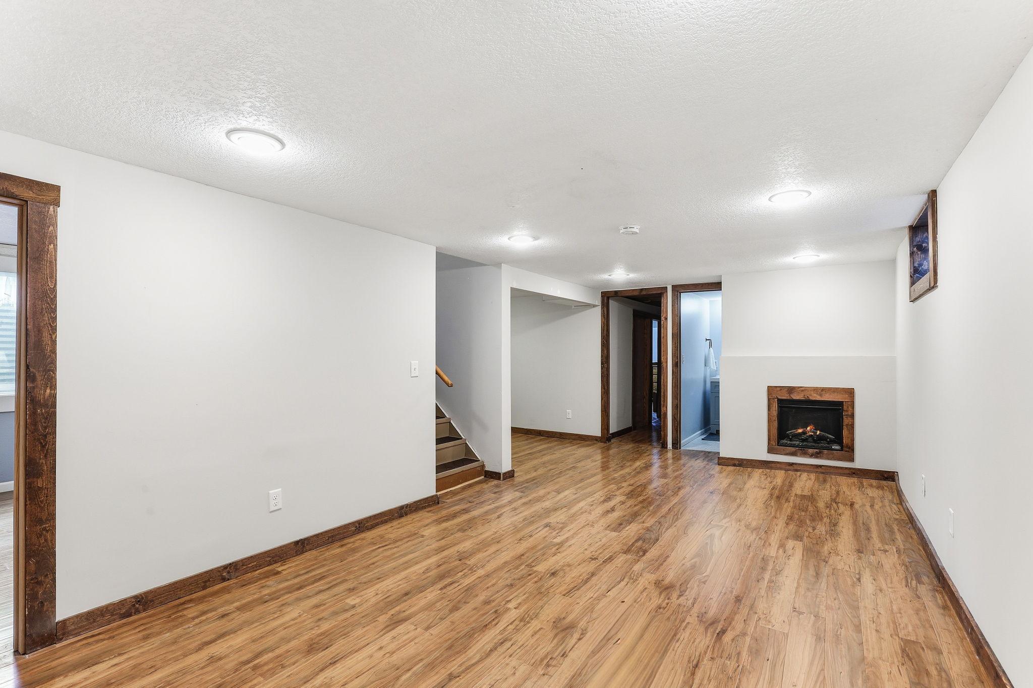 Updated lower level featuring new drywall (2018), a converted electric fireplace with a built-in blower (2018), recessed lighting (2018) and NEW LPV flooring (2025). Modern upgrade adds warmth and creates a clean, refreshed space.