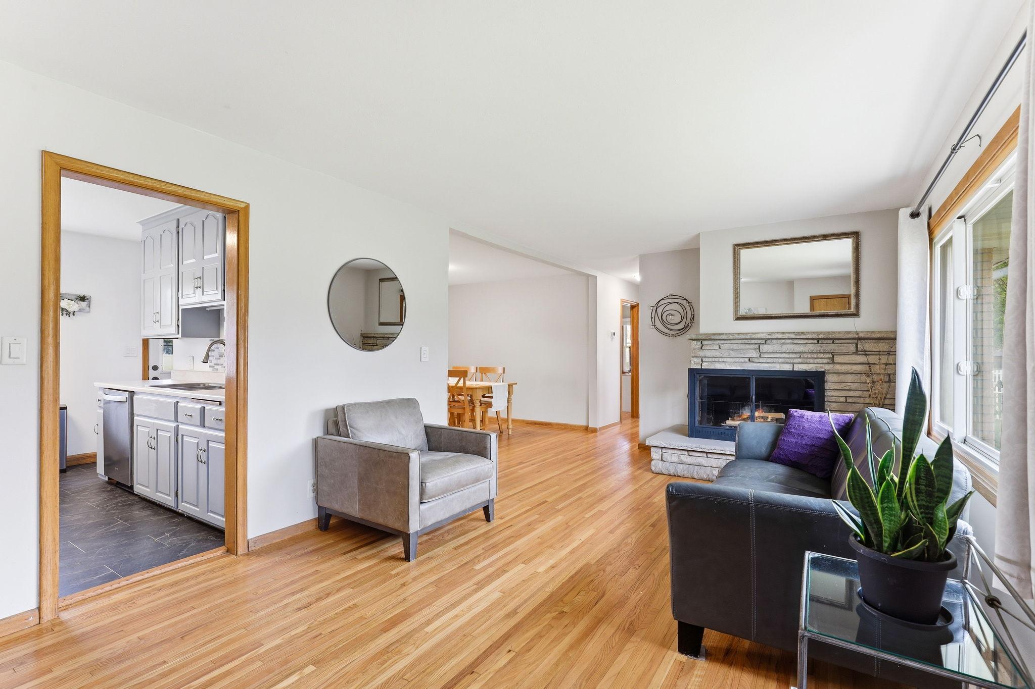 Refinished hardwood floors (2025) bring warmth and elegance to the space, showcasing rich natural grain patterns and a smooth, polished finish.