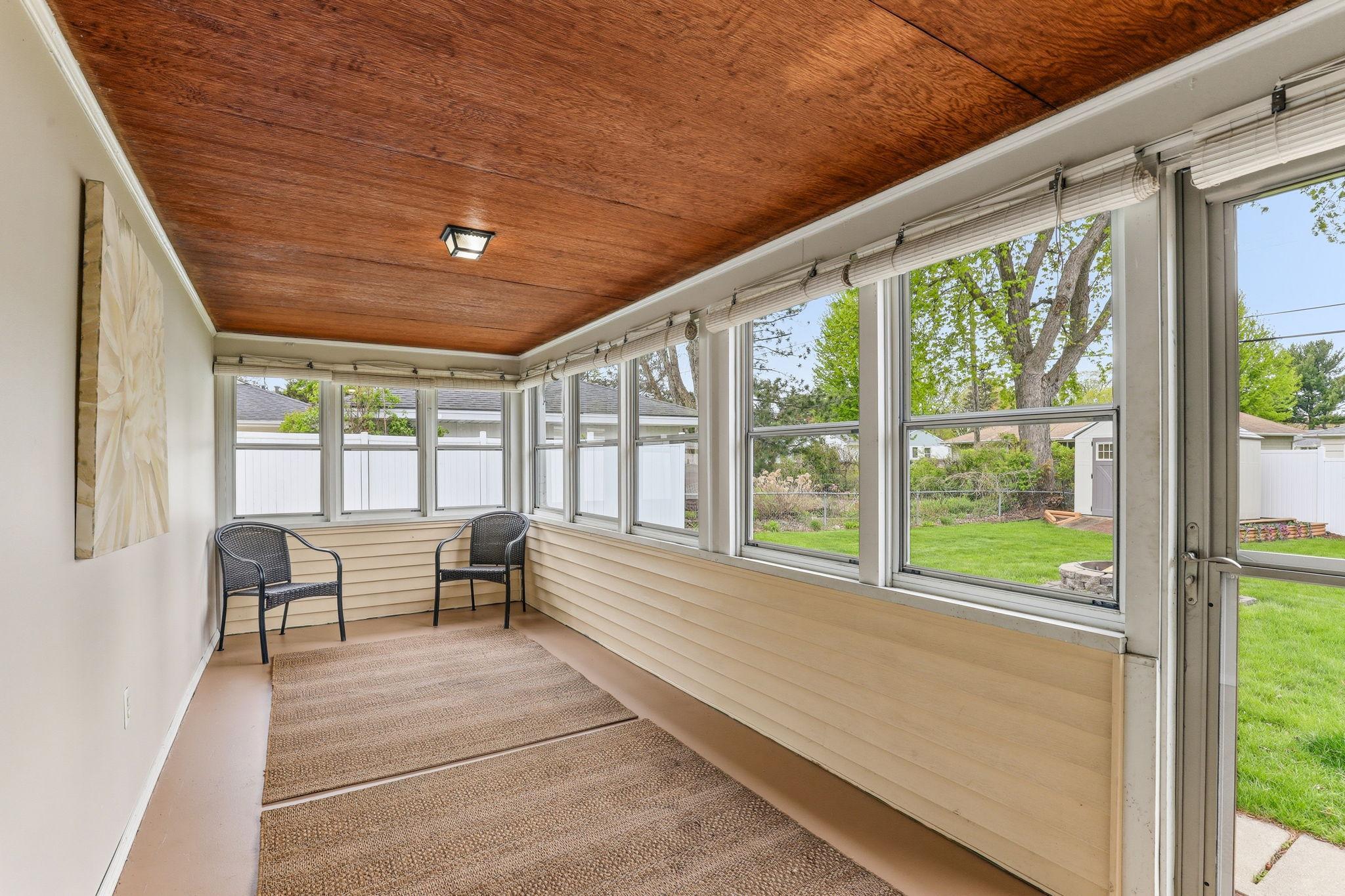 Bright breezeway offering a seamless transition between indoor and outdoor spaces. The area provides a functional, airy connection with plenty of natural light.