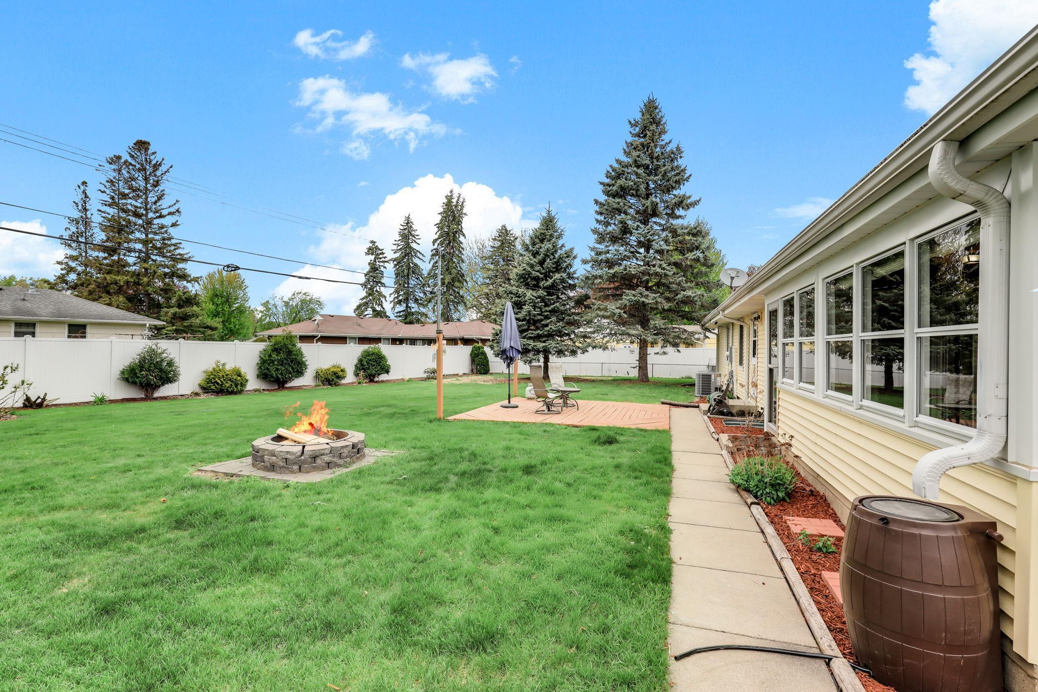 Outdoor oasis created NEW privacy fence (2024) NEW fire pit (2023) and NEW landscaping (2023).