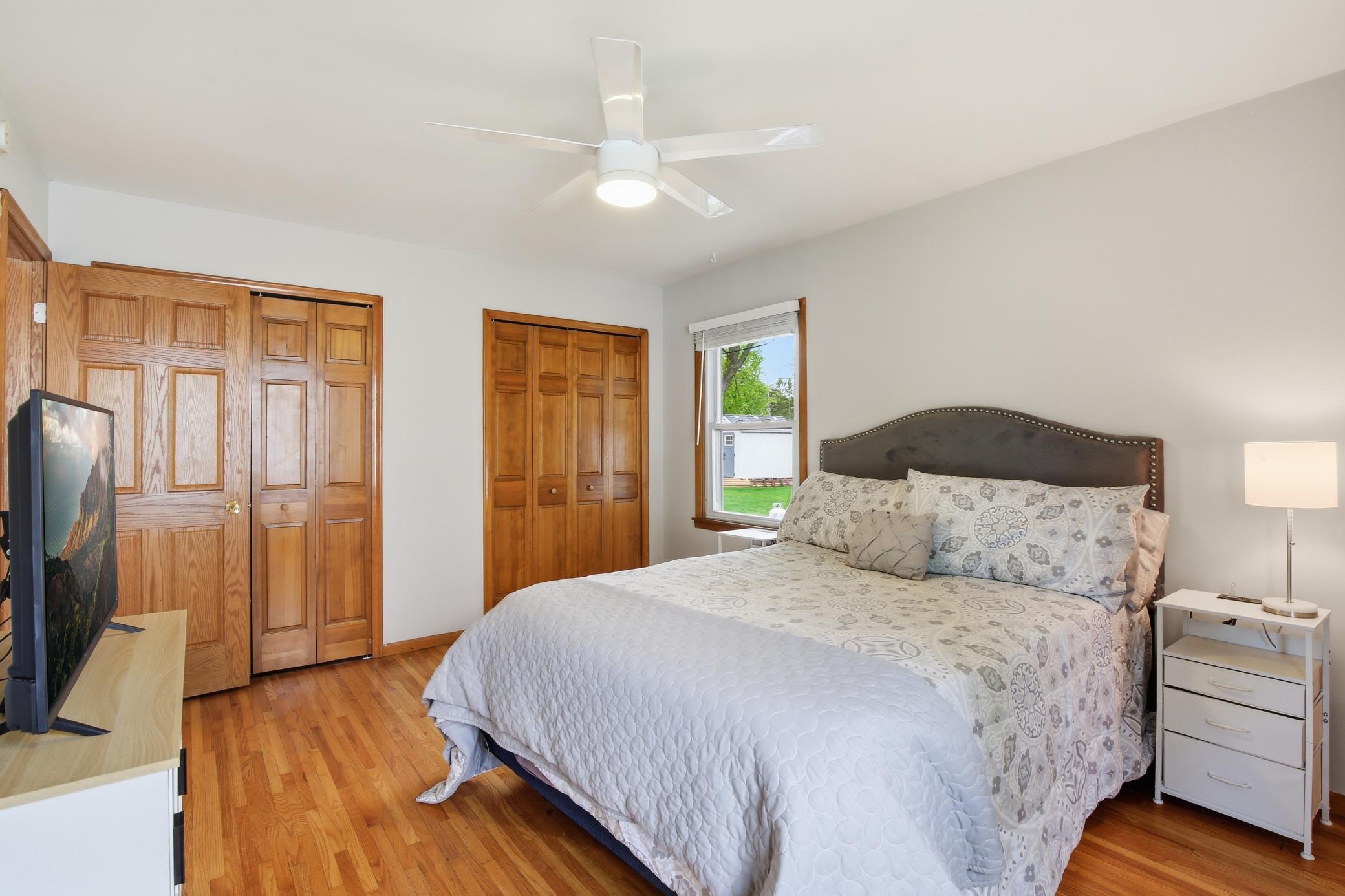 Primary bedroom offers dual closets and beautiful hardwood floors.