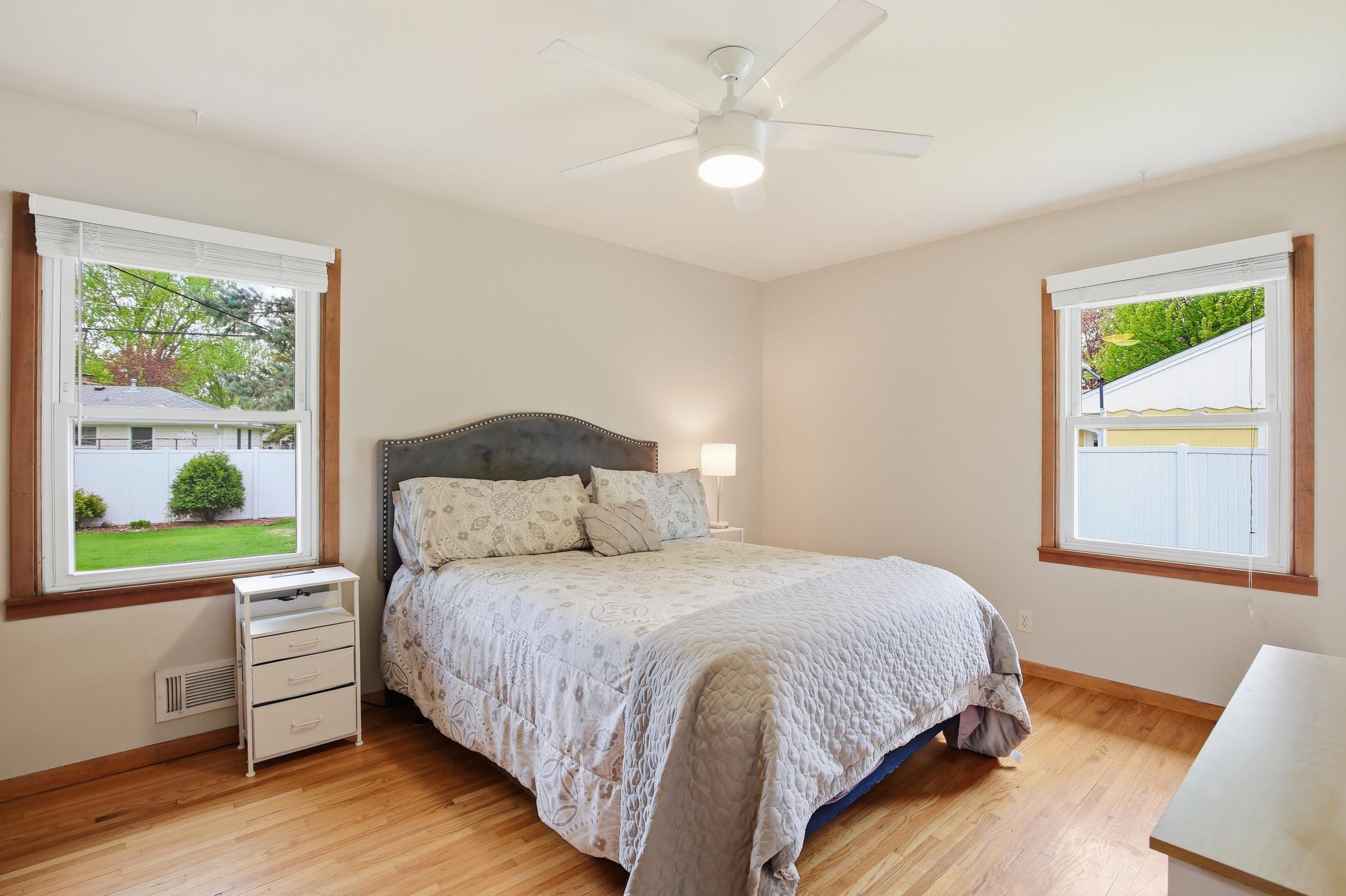 Main-floor primary bedroom featuring soft natural light, warm neutral tones, and a relaxing atmosphere.