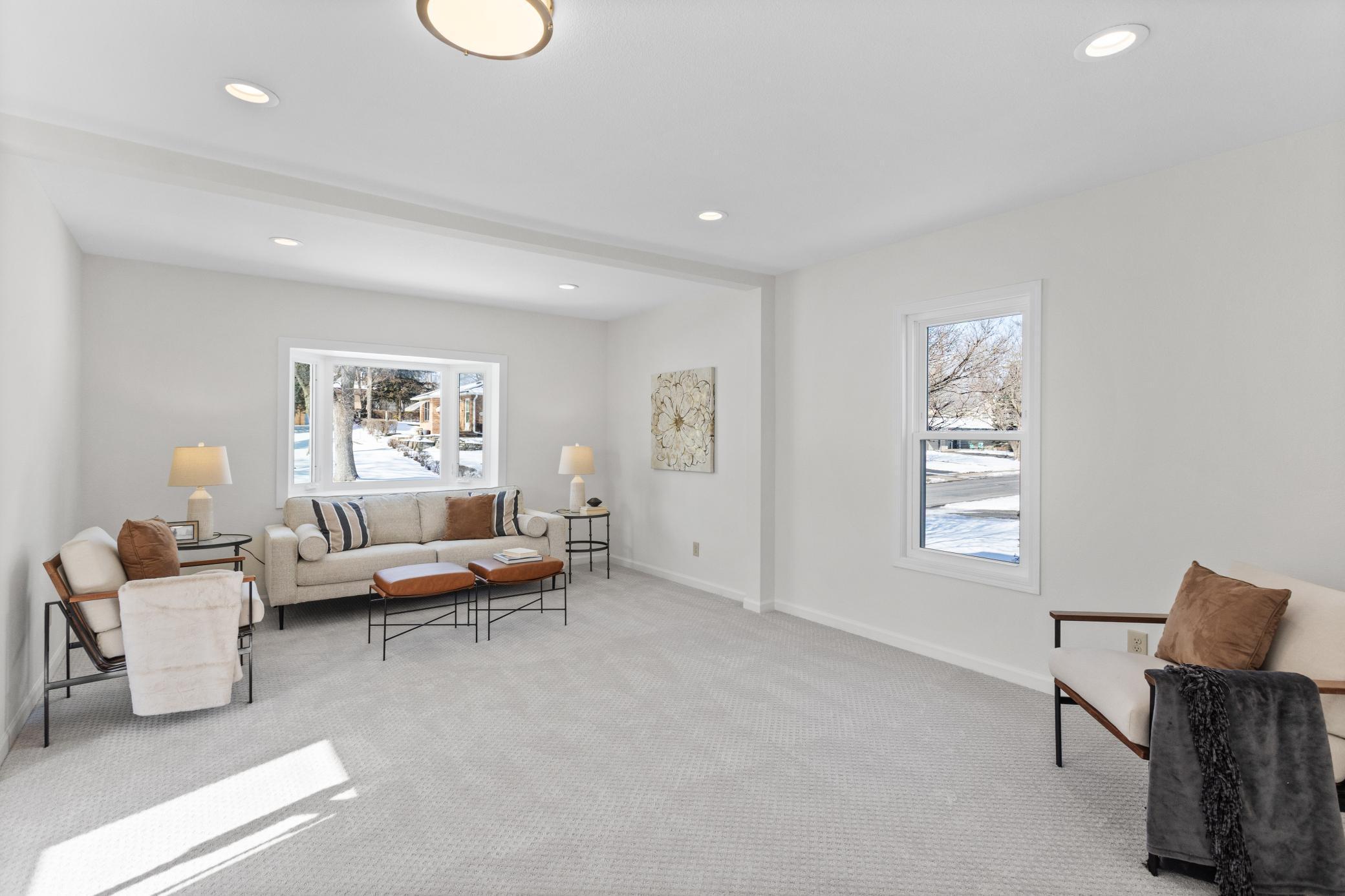 Spacious living room with fresh paint throughout, new carpet and natural light through the bay window.