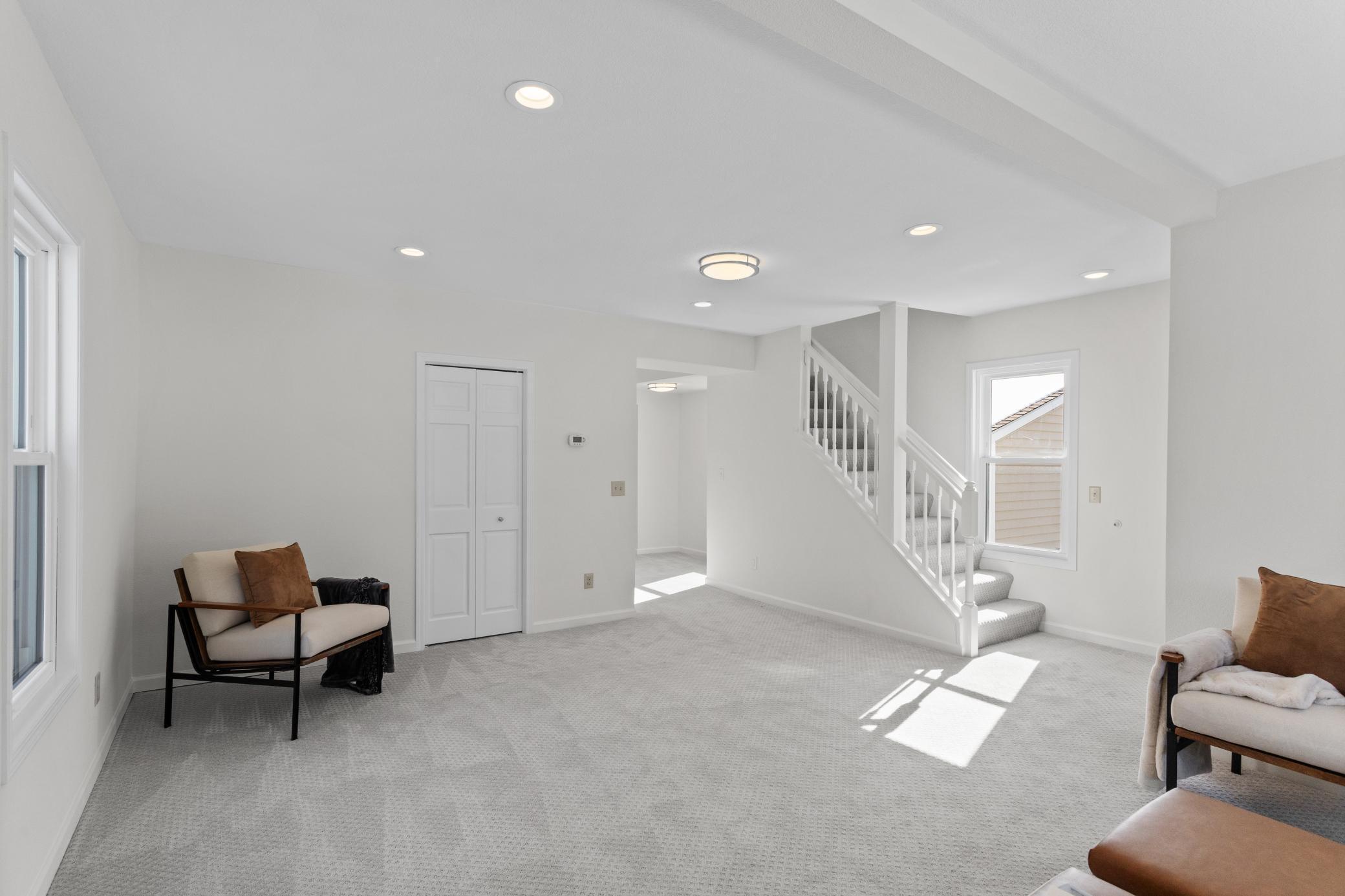 Living room angle with stairs leading up.