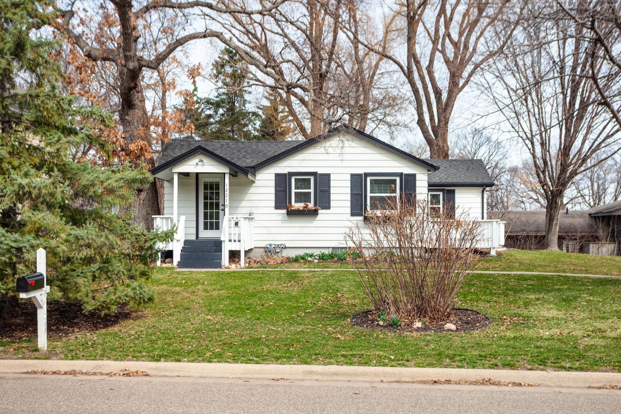 Picture perfect lake area cottage is sited in a fabulous neighborhood near the shores of Medicine Lake and showcases charm and curb appeal from its covered front porch to its lovely shutters and window boxes. Wayzata Schools!