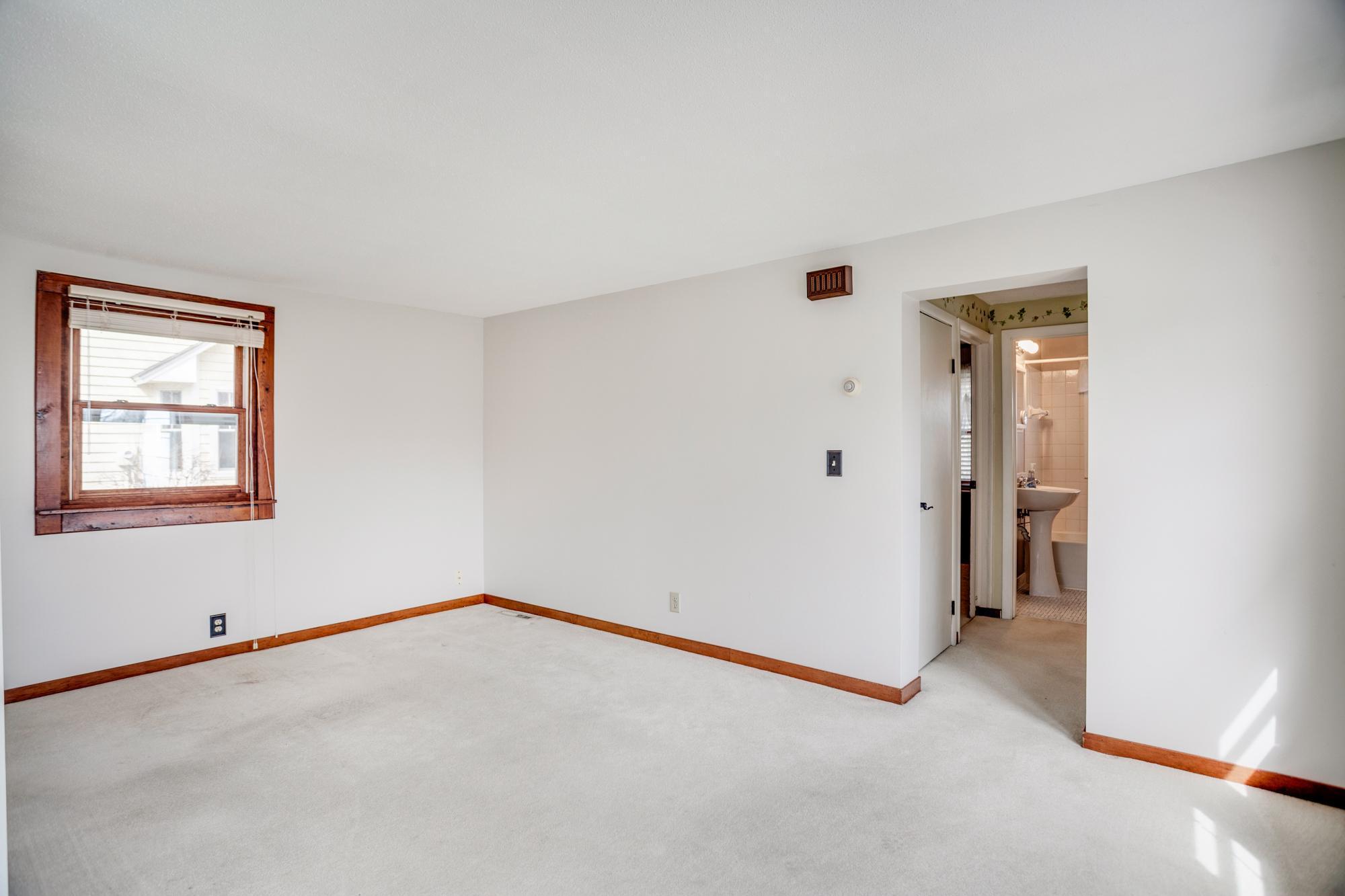 Living room area + a peek down the hallway that leads to the two bedrooms and full bath.