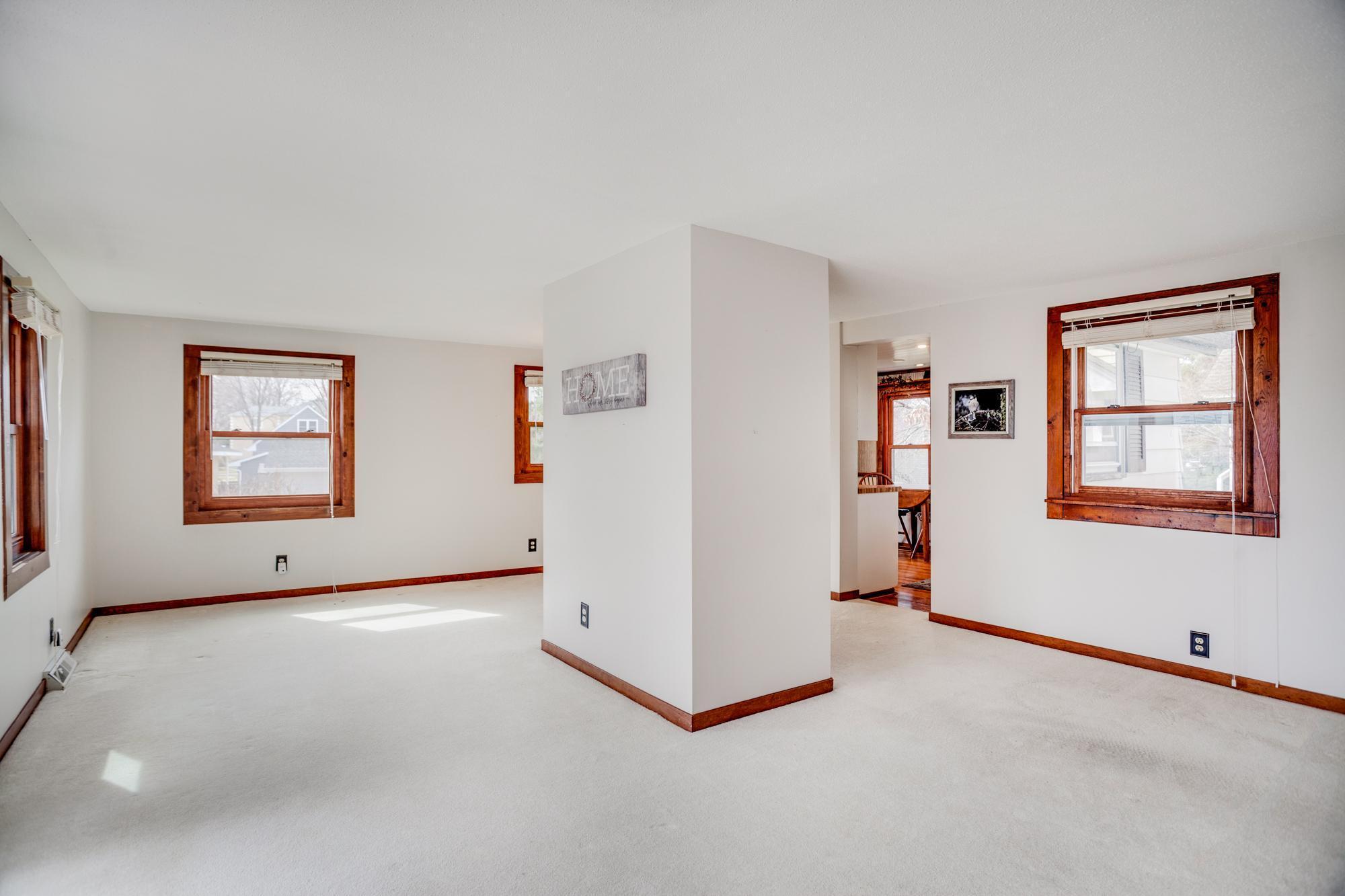 An alternative view of the open main level. A centrally located closet creates a natural divide between the dining room and living room spaces.