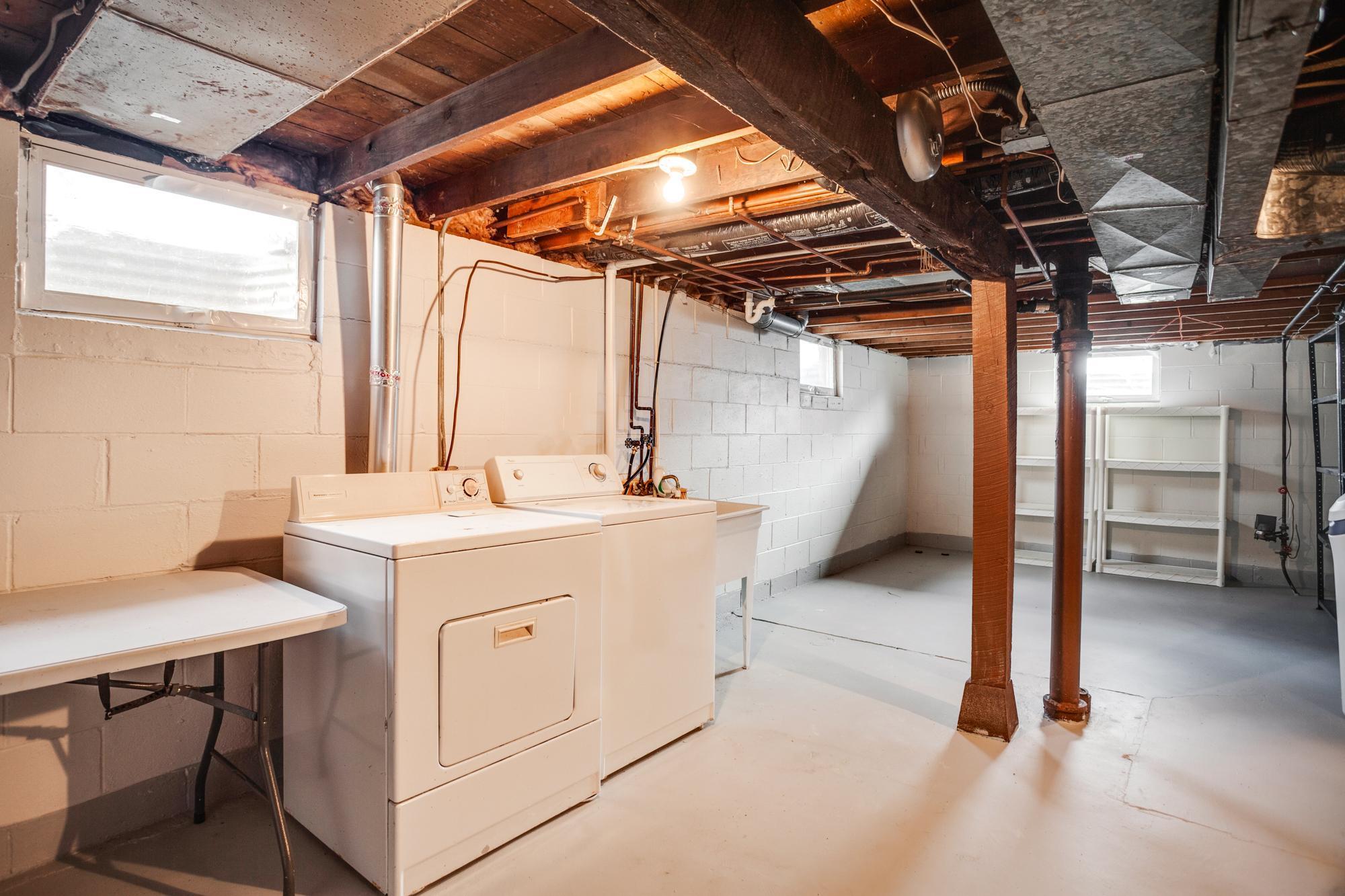 The unfinished lower level is home to the laundry area + a large storage space.