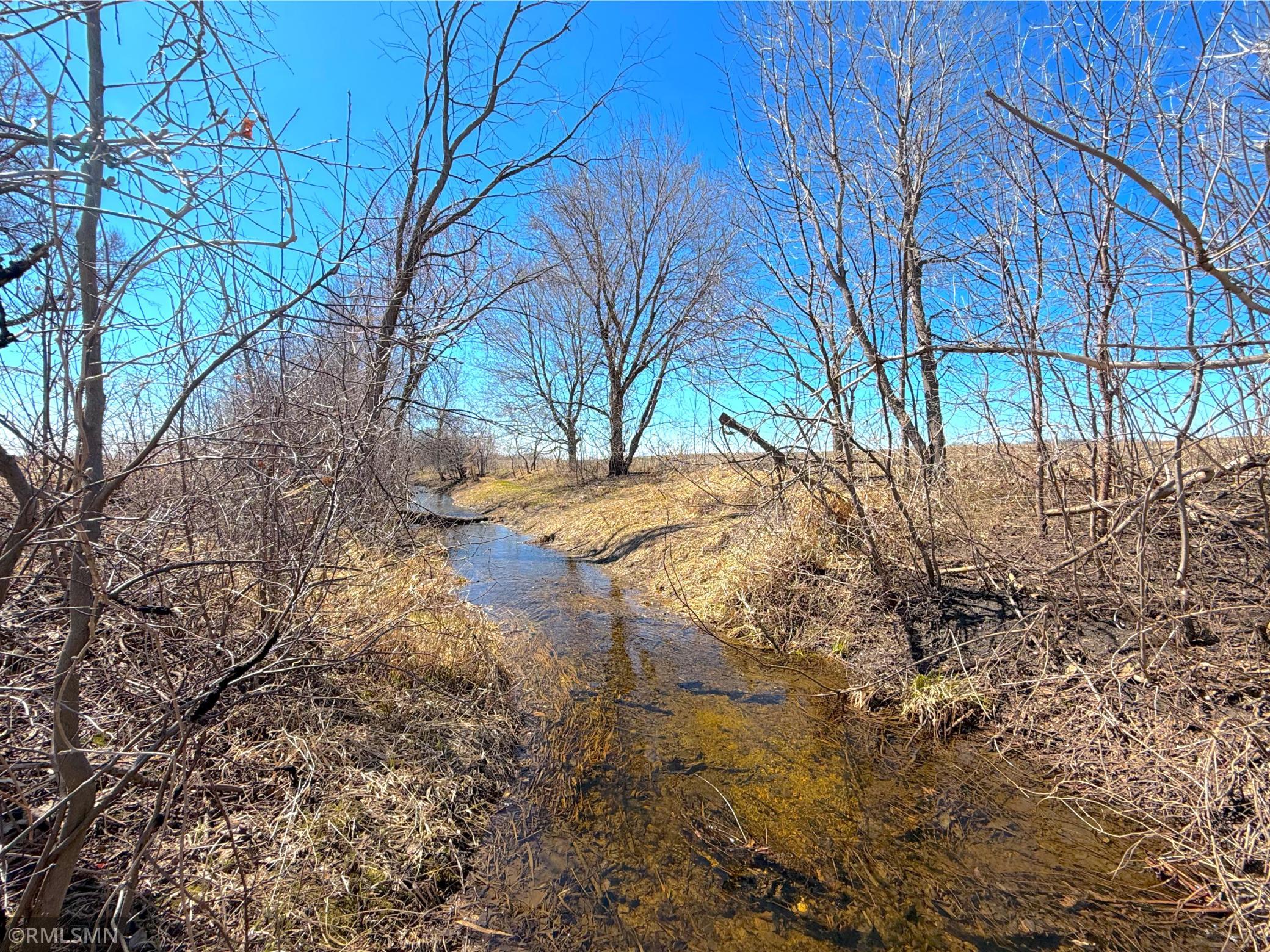 Extensive improvements along the northwest boundary include a jointly managed creek that has been dredged and widened to enhance water flow and overall land usability.