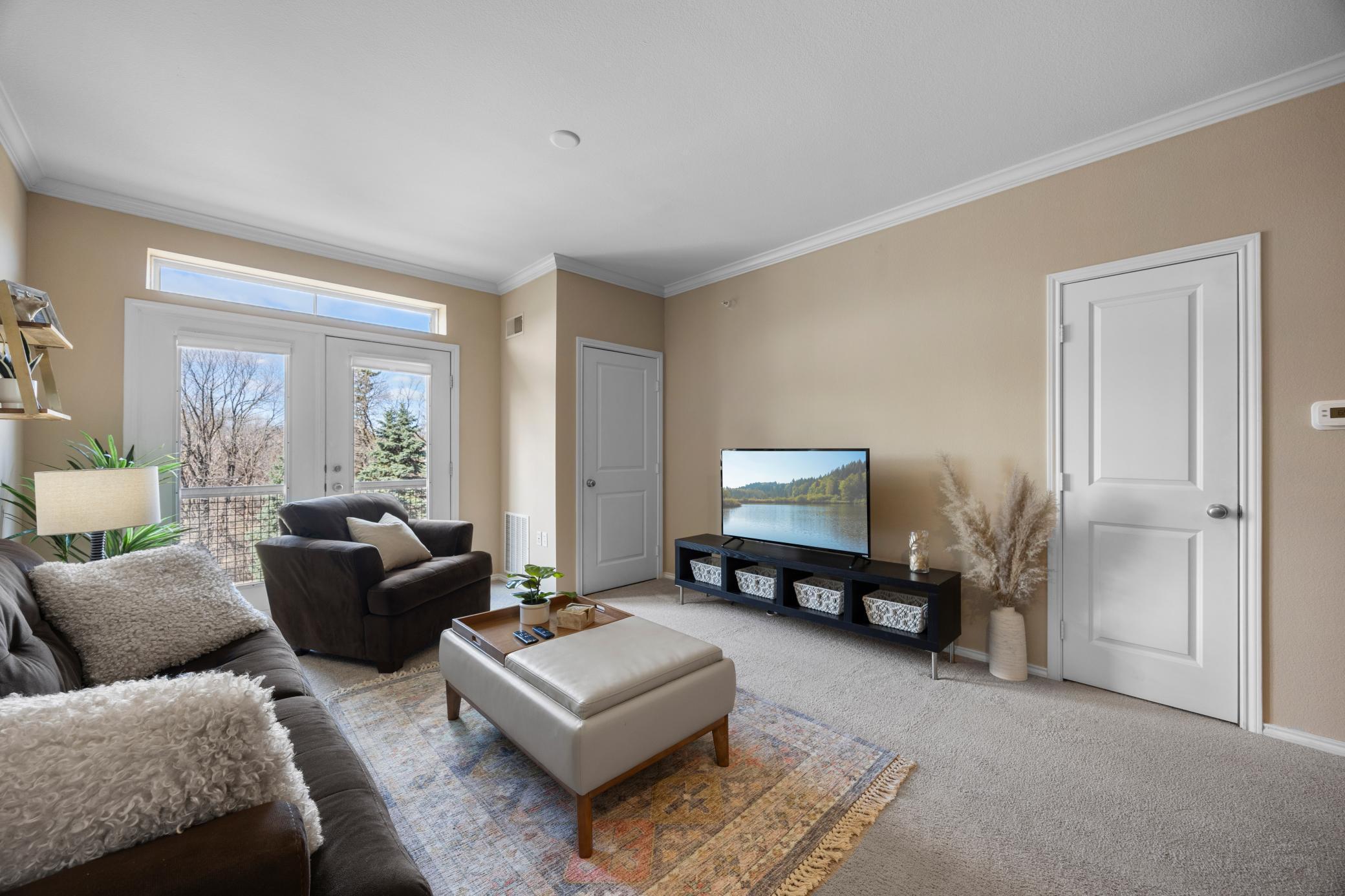 Another view of the living room. The door next to the double doors looking out is the furnace room. Nicely tucked away but with easy access if needed.