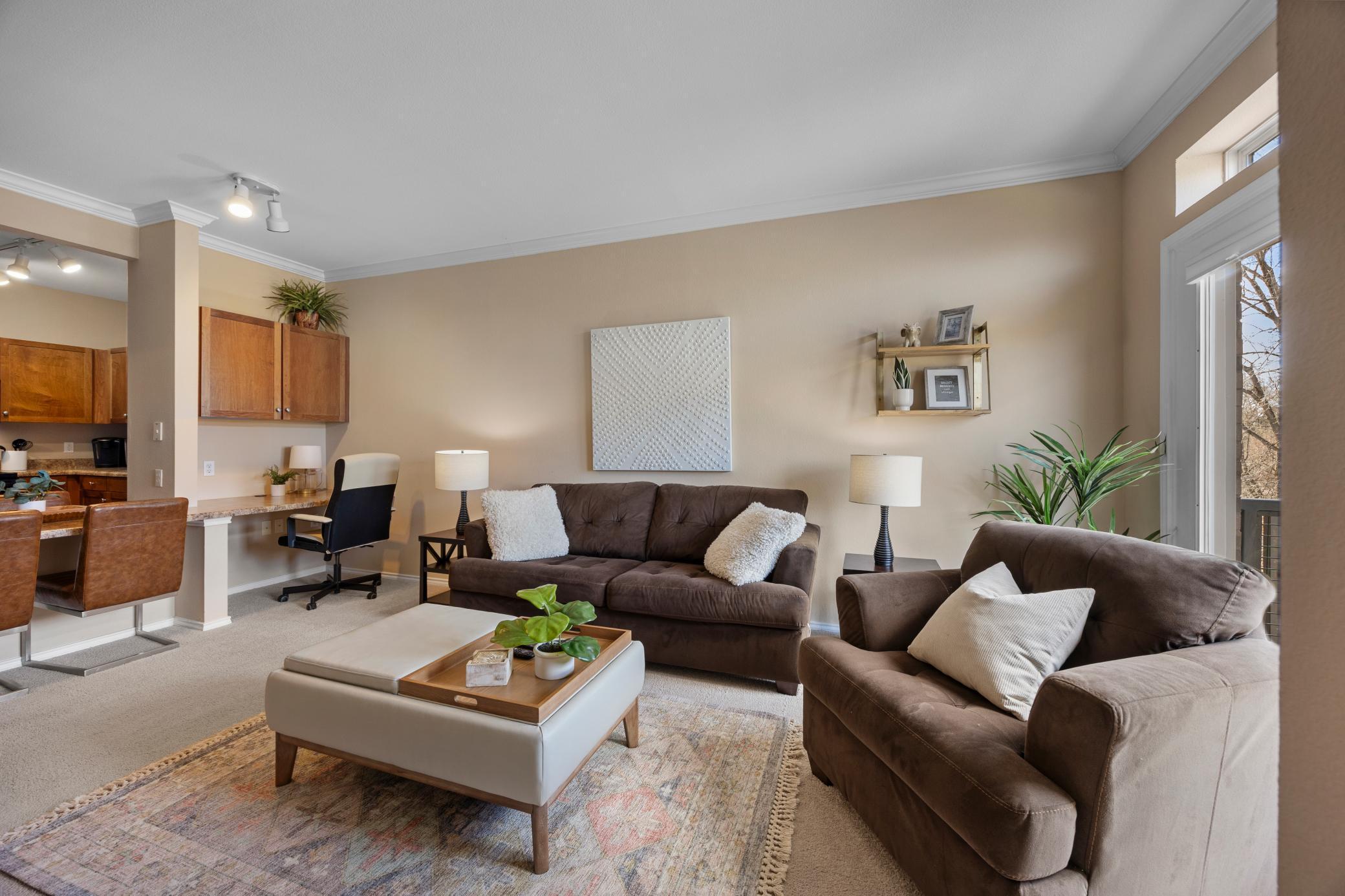 A view of the living room looking at the built in desk and dining area.