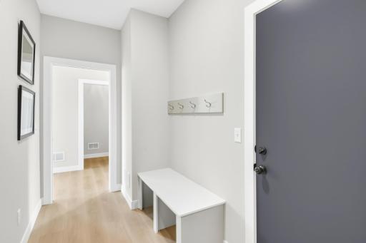 Built in bench and hools are located in the mudroom space.