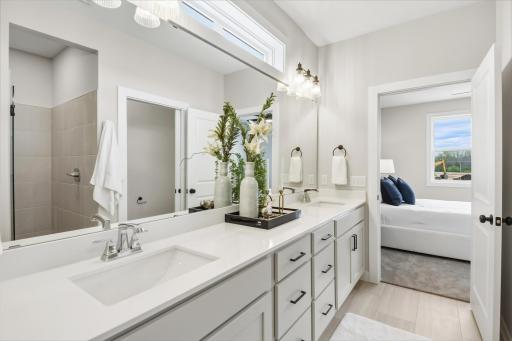 The primary bath offers double bowl sink & large tile shower.