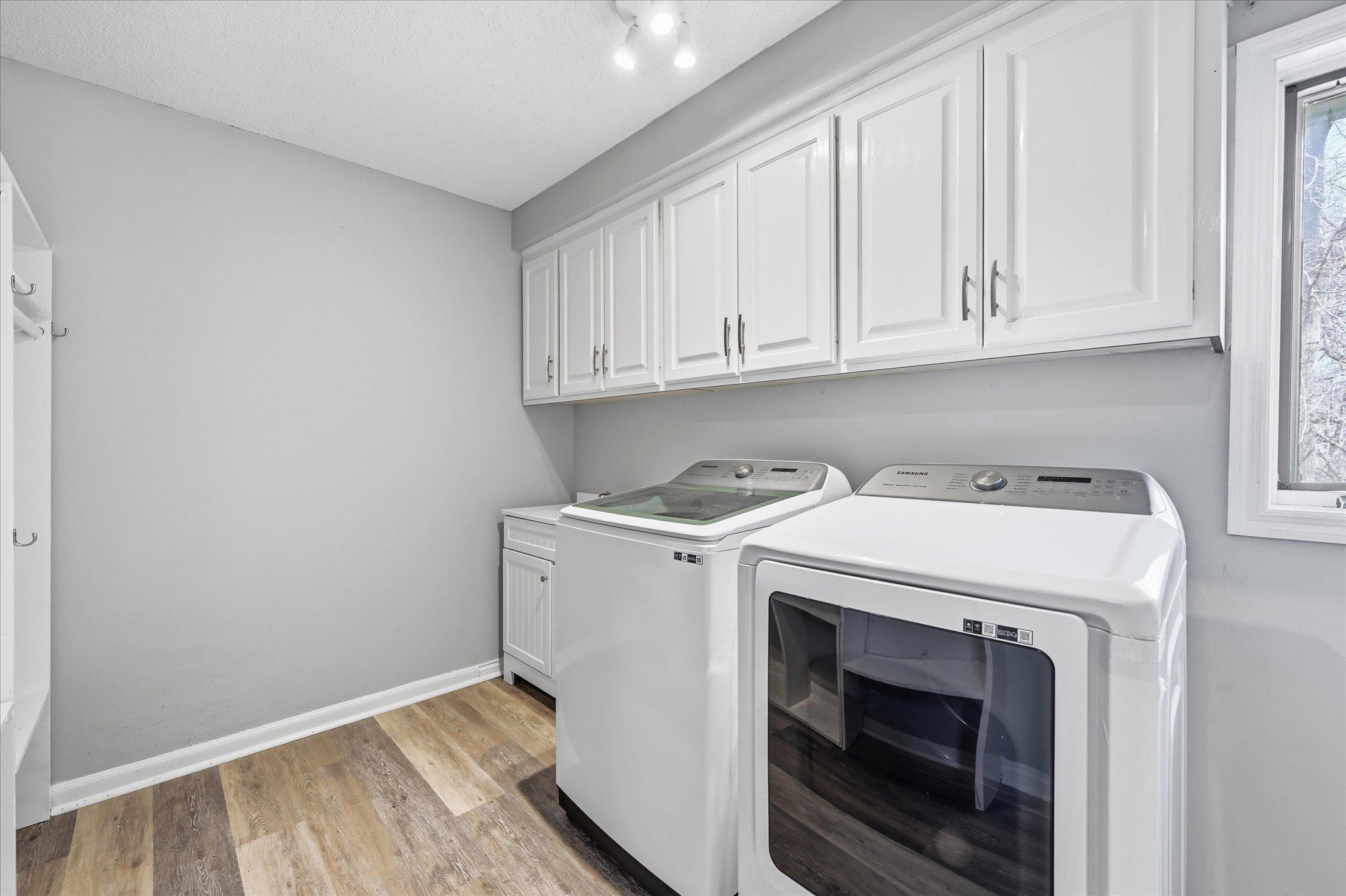 Main floor large laundry room with sink and cubbies for coats.