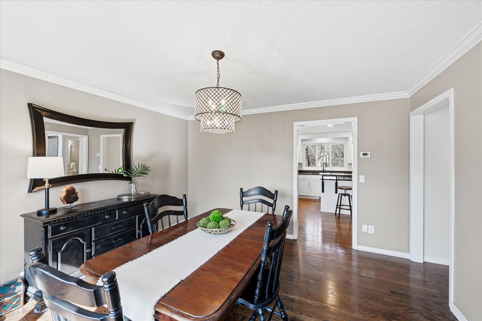 Step from the kitchen to your large yet gorgeous formal dining room with crown molding ceilings and private views.