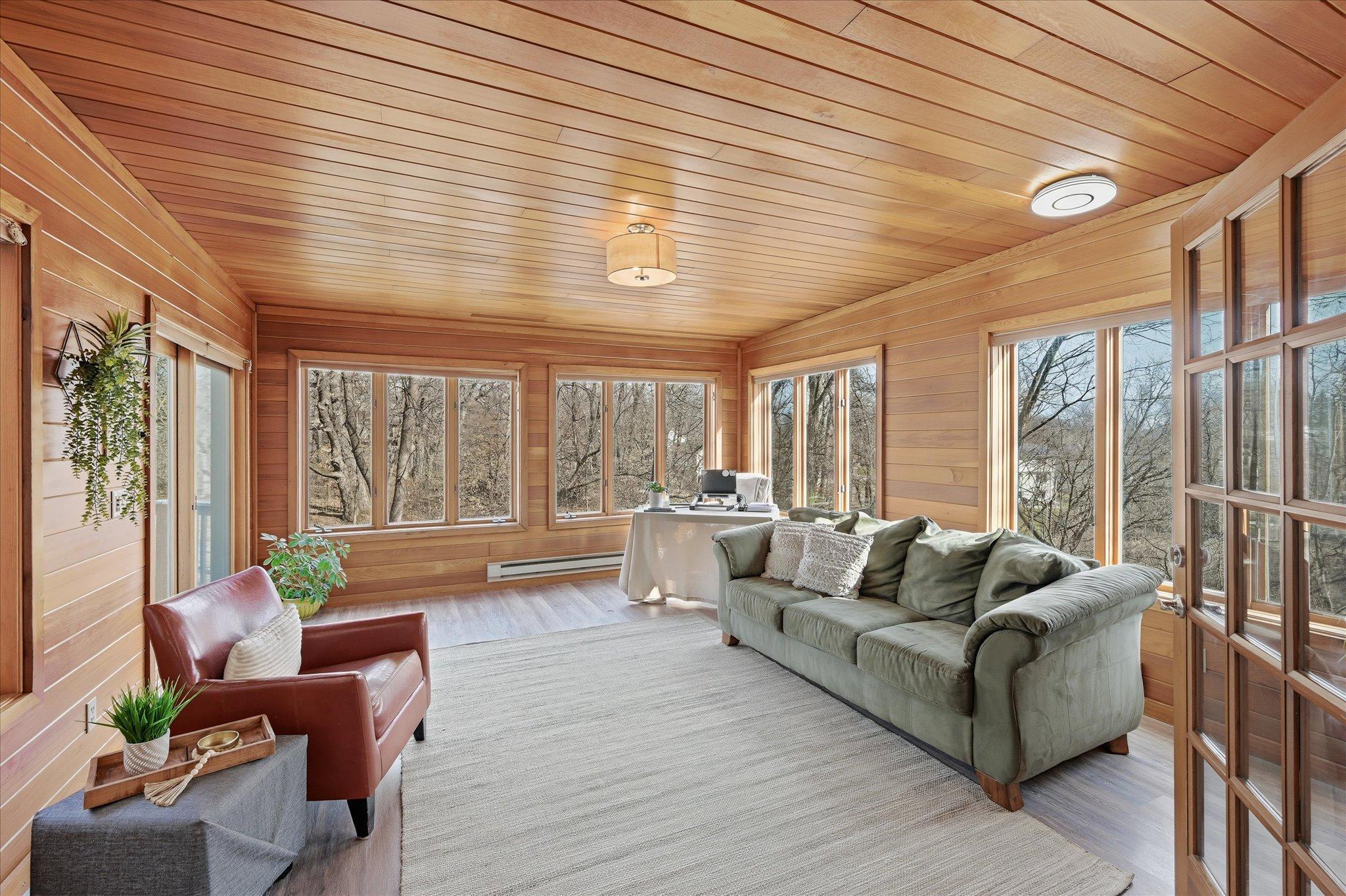 Let's jump right into our favorite room. You will feel as if you're sitting in a birdhouse! Additional baseboard heat four season room is for sure a highlight.