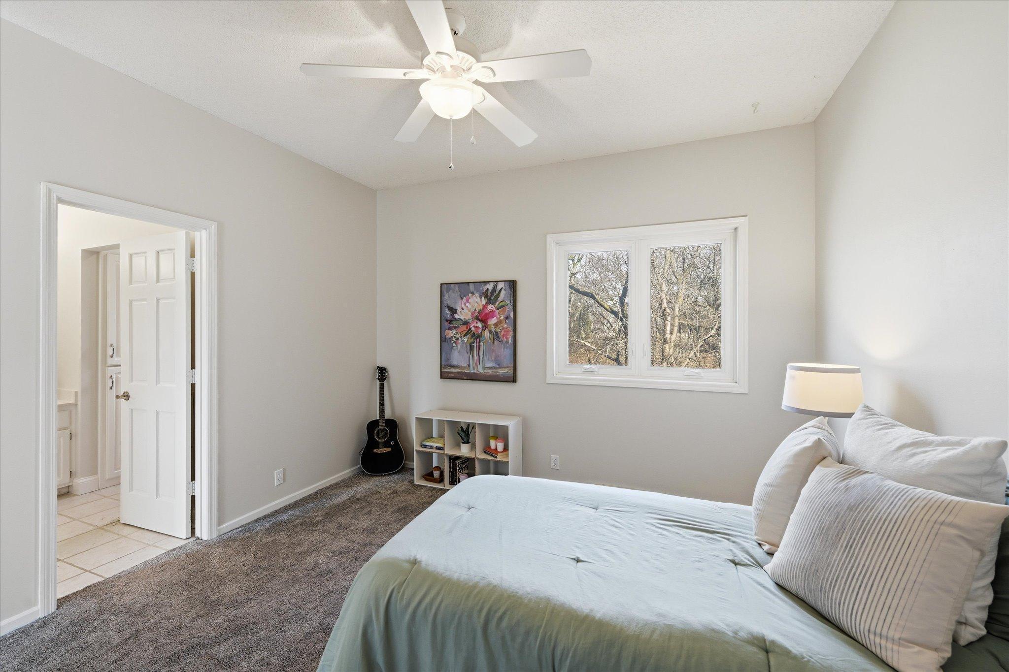 Third upper level bedroom with beautiful views and walks through to full bath.