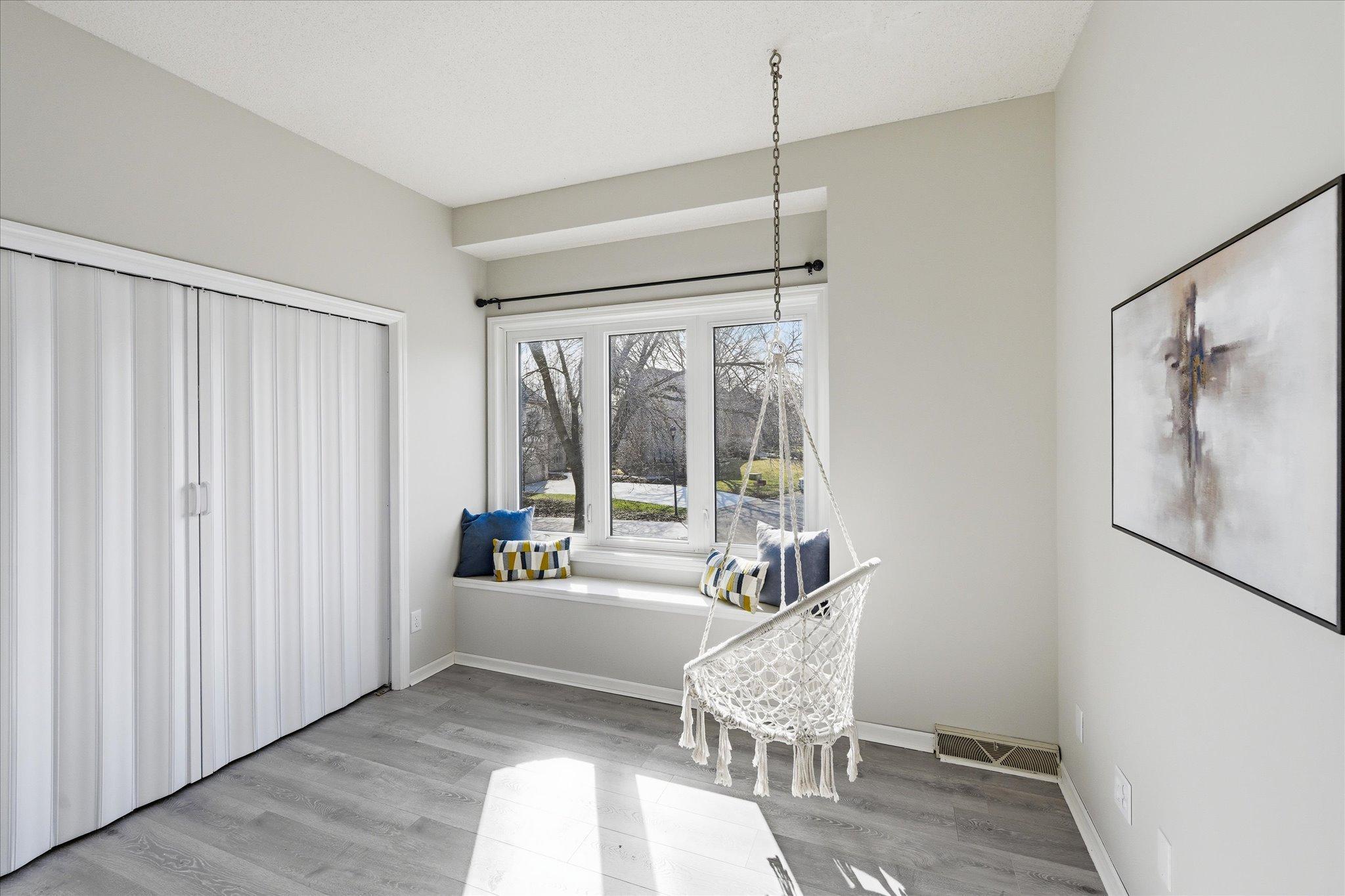 Fourth upper level bedroom with window seat.