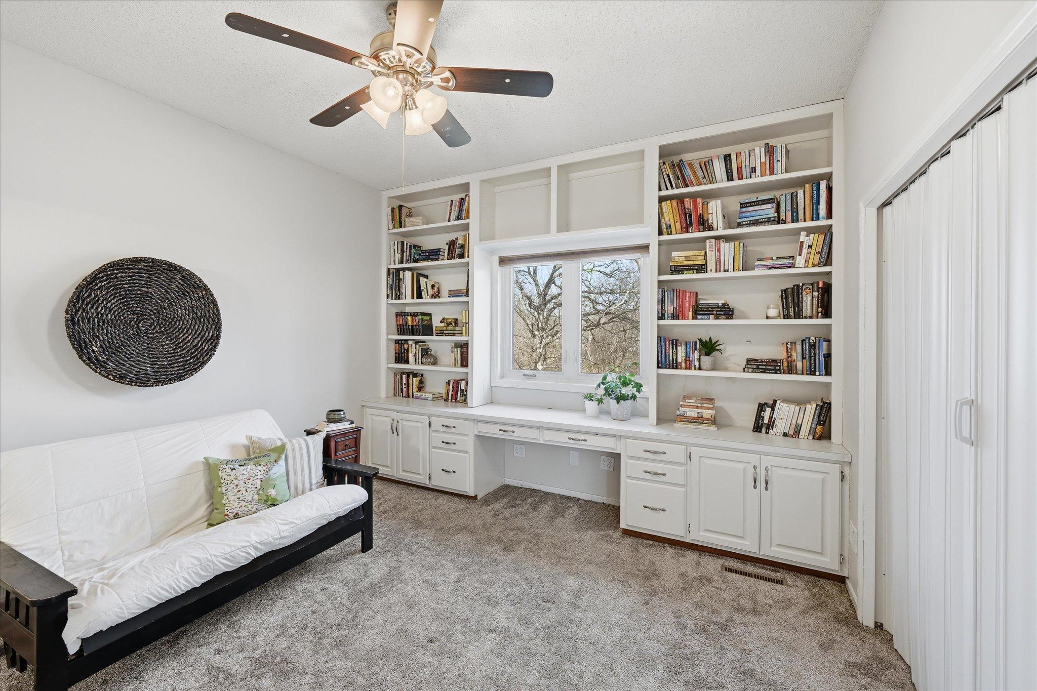 Upper level bedroom with built in desk and shelves, large closet and private full bath.