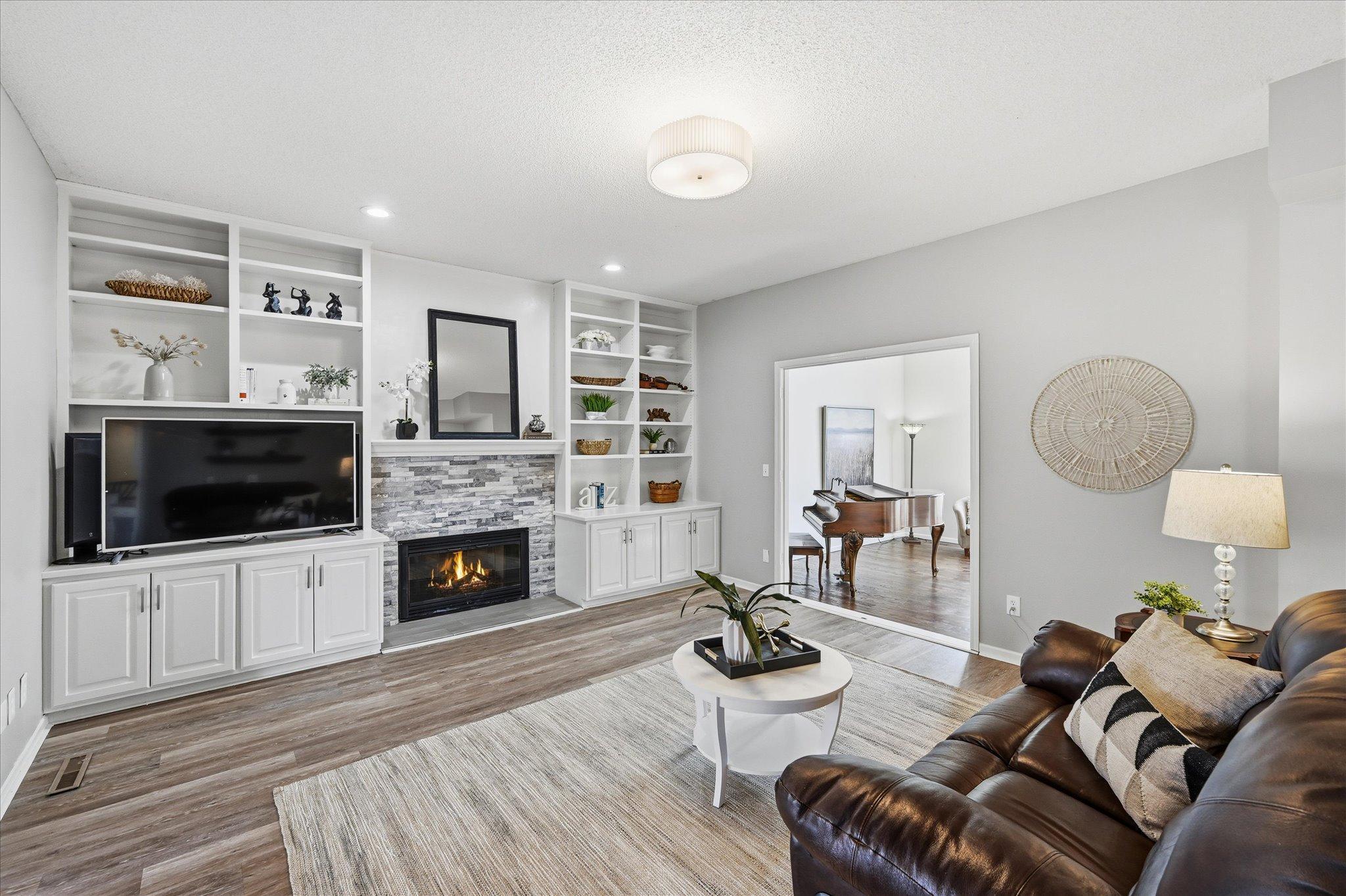 Main floor family room with built ins and gas fireplace.