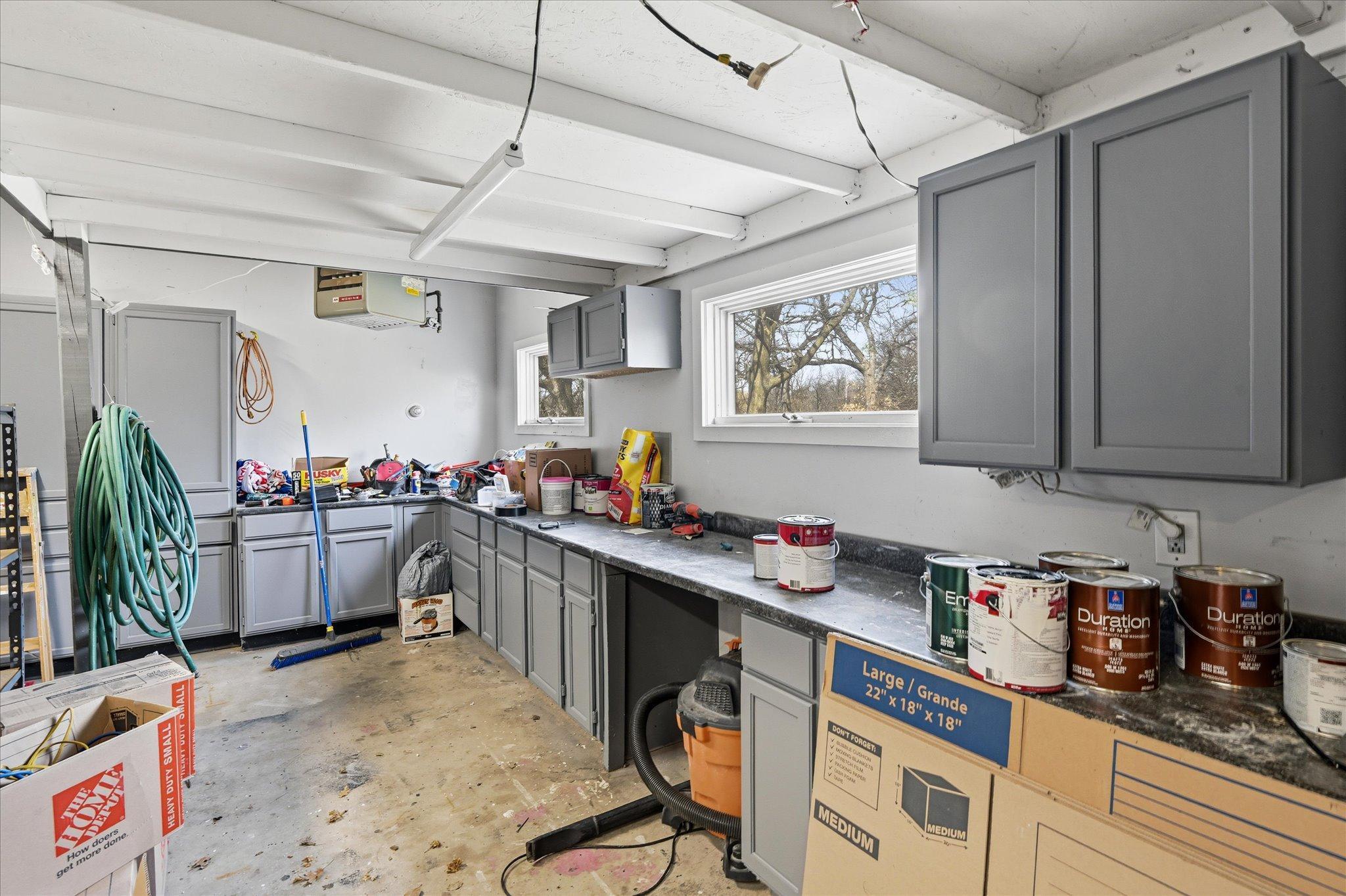This is bonus space in the rear of the huge three car heated garage. (Please excuse the mess...great place to work on projects!) Access the backyard through service door to the side.
