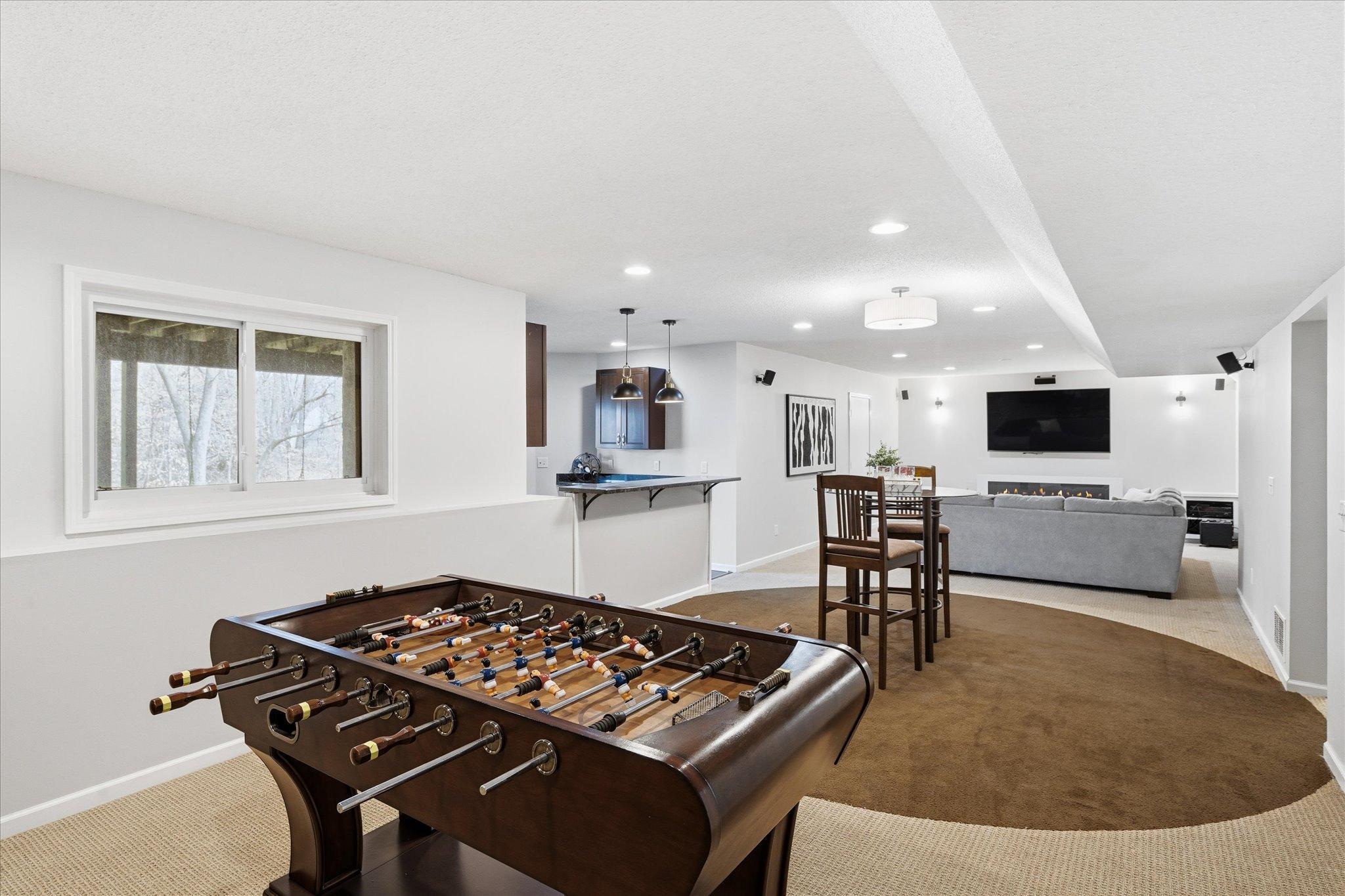 Game room in lower level. Don't miss the built ins and custom seating area/reading nook.