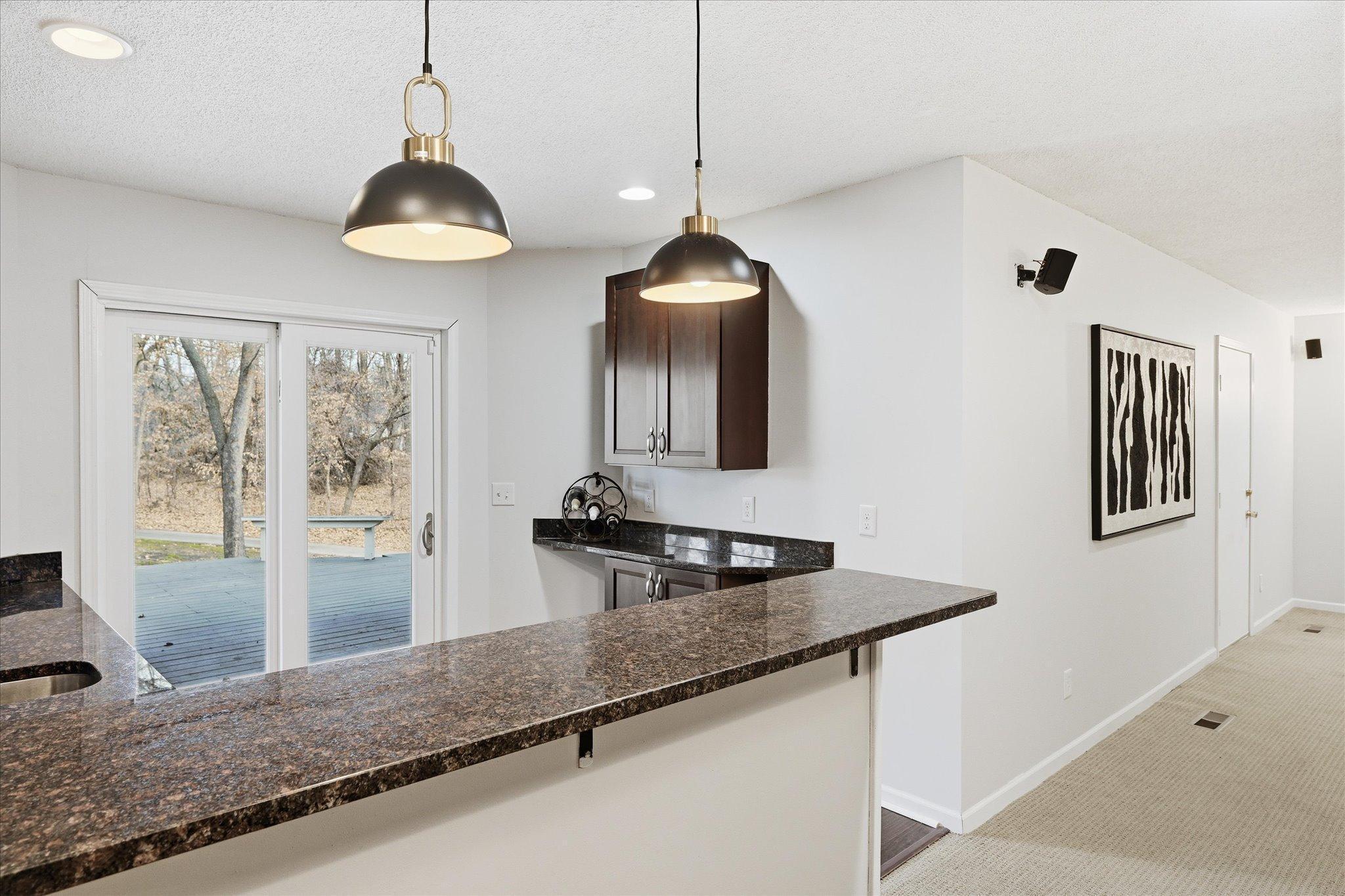 Lower level bar with plenty of room for stools or walk up entertaining.