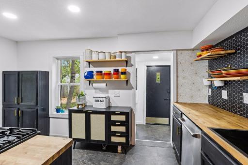 Stylish and whimsical kitchen remodeled in 2024, additional updates include a new sink, dishwasher and open shelving.